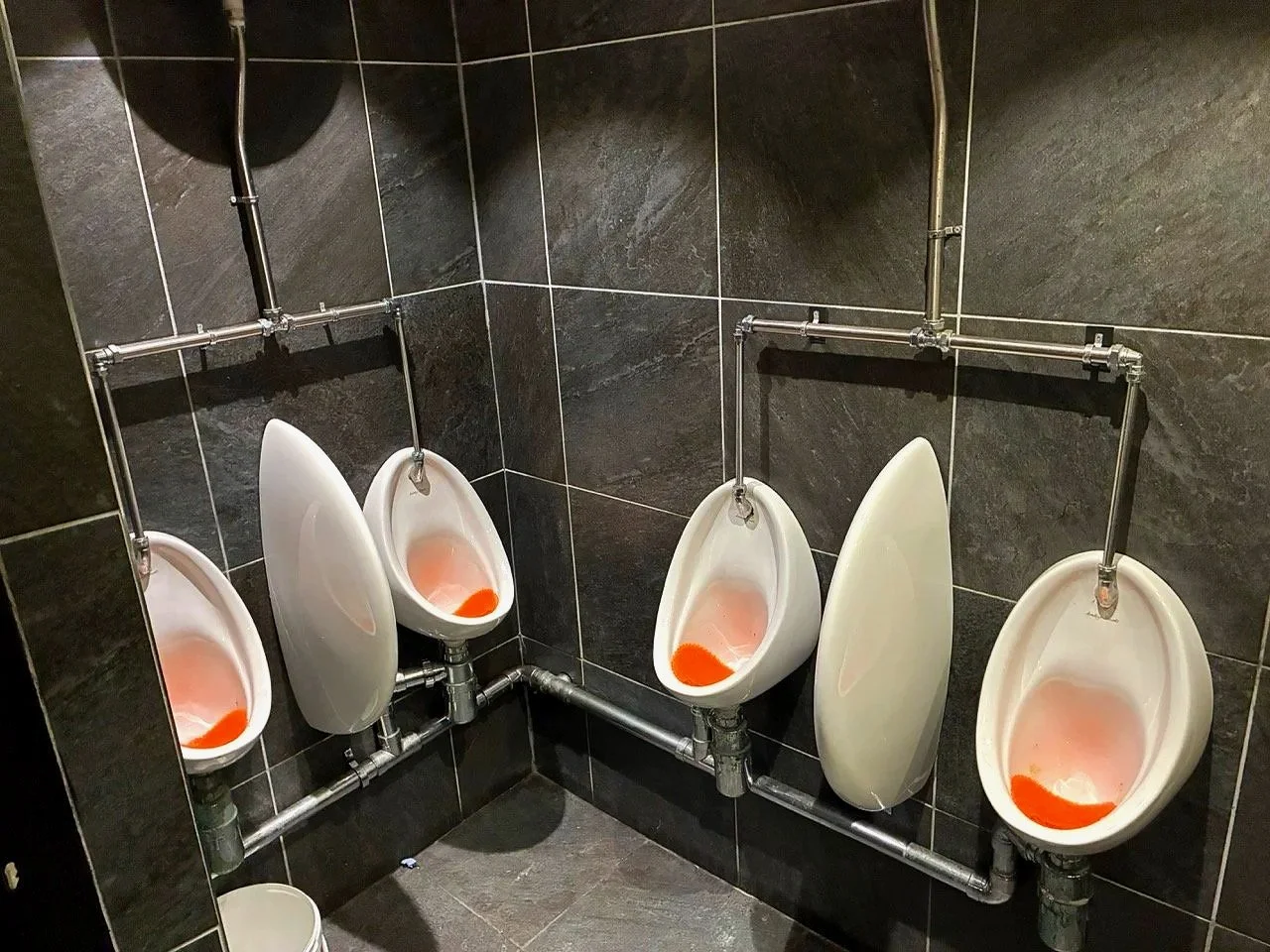 ...please don't see them as urinals - but as sculpture! and the orange inserts are NHS messages "Blood in your urine? Call your GP."