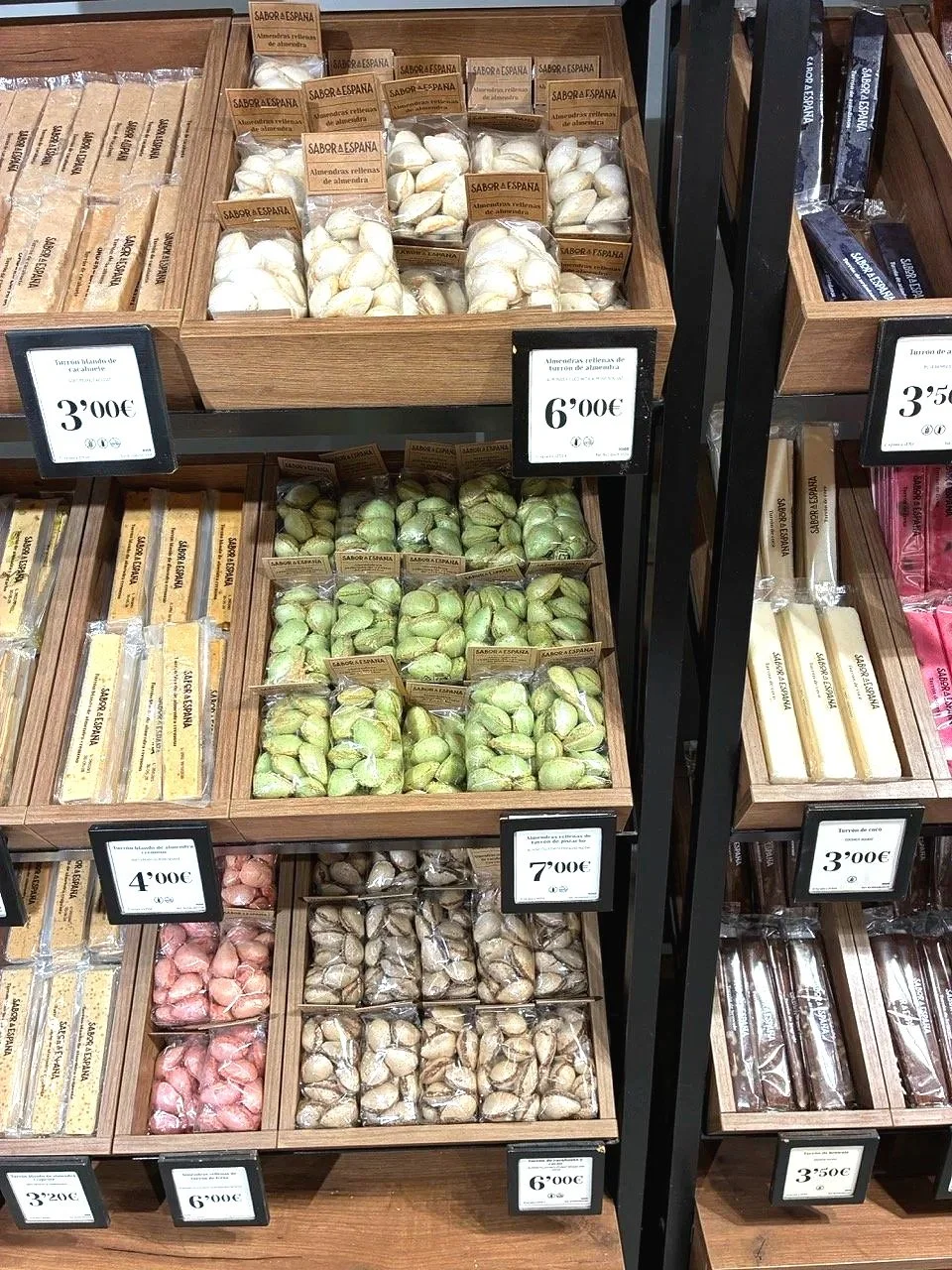 ...quite a few sweet shops: caramelized sunflower seeds/cashews are typical and many forms of turón, a nutted nougat. The candies, shaped like unhulled almonds. stood out