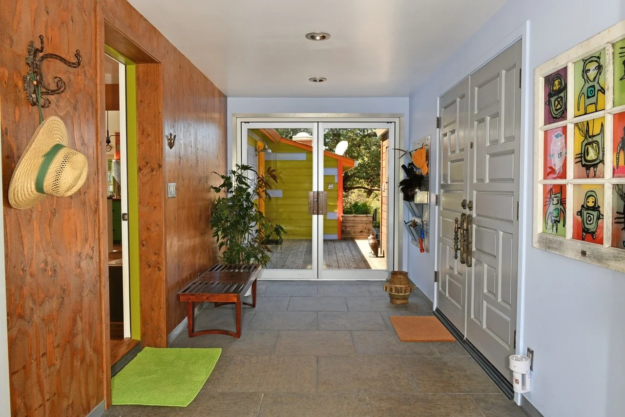 Vestibule, commercial doors at each end, plywood wall, slate floor - sadly had to paint the doors...
