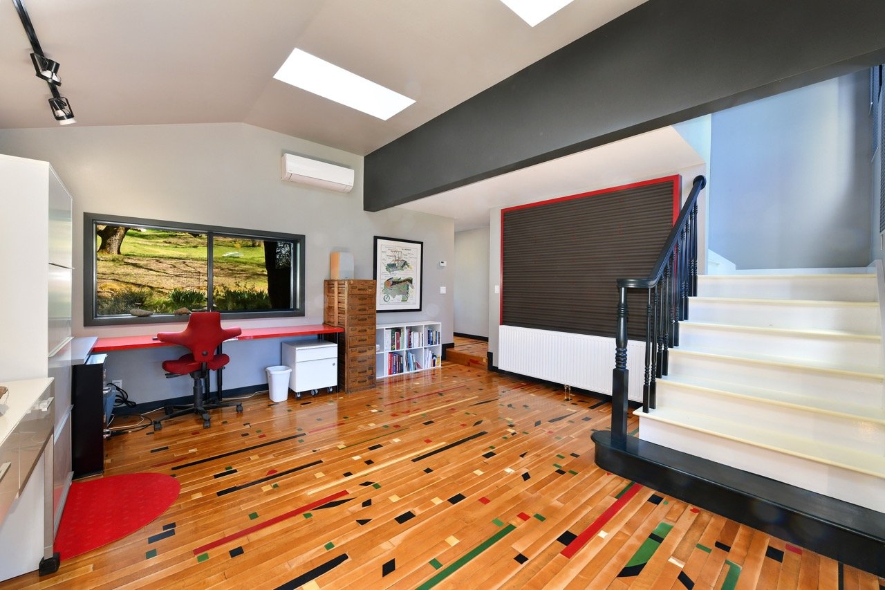 Office, but could be a bowling alley! actually they are recovered bowling alley planks, much sanding to make level enough to walk on, steps up to main bedroom...