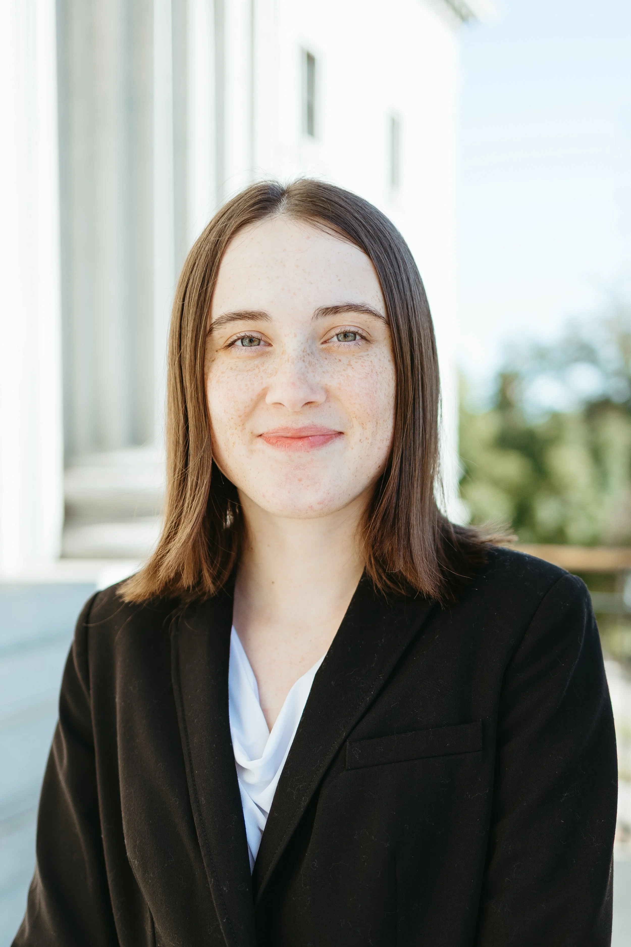 Headshot of Sydney Wilson, white female with brown hair and hazel eyes