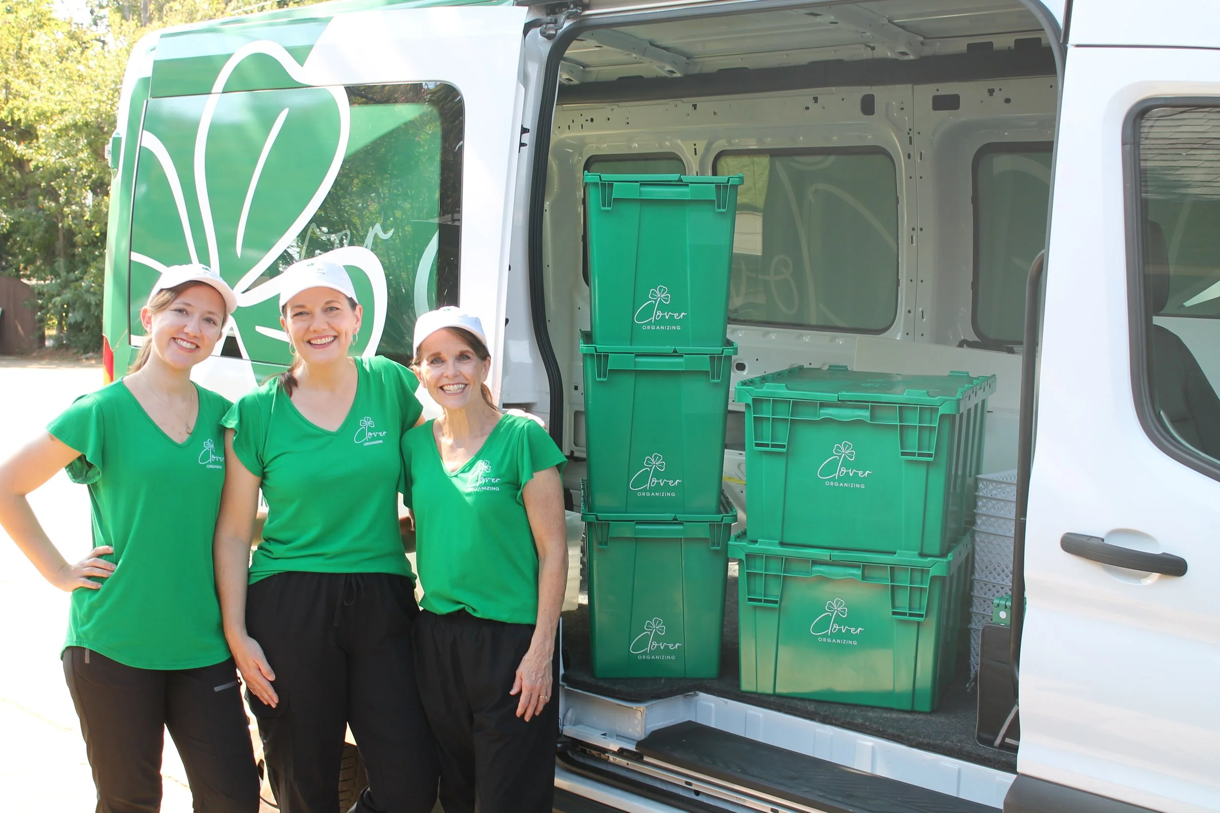 Three Organizers standing in front of a van