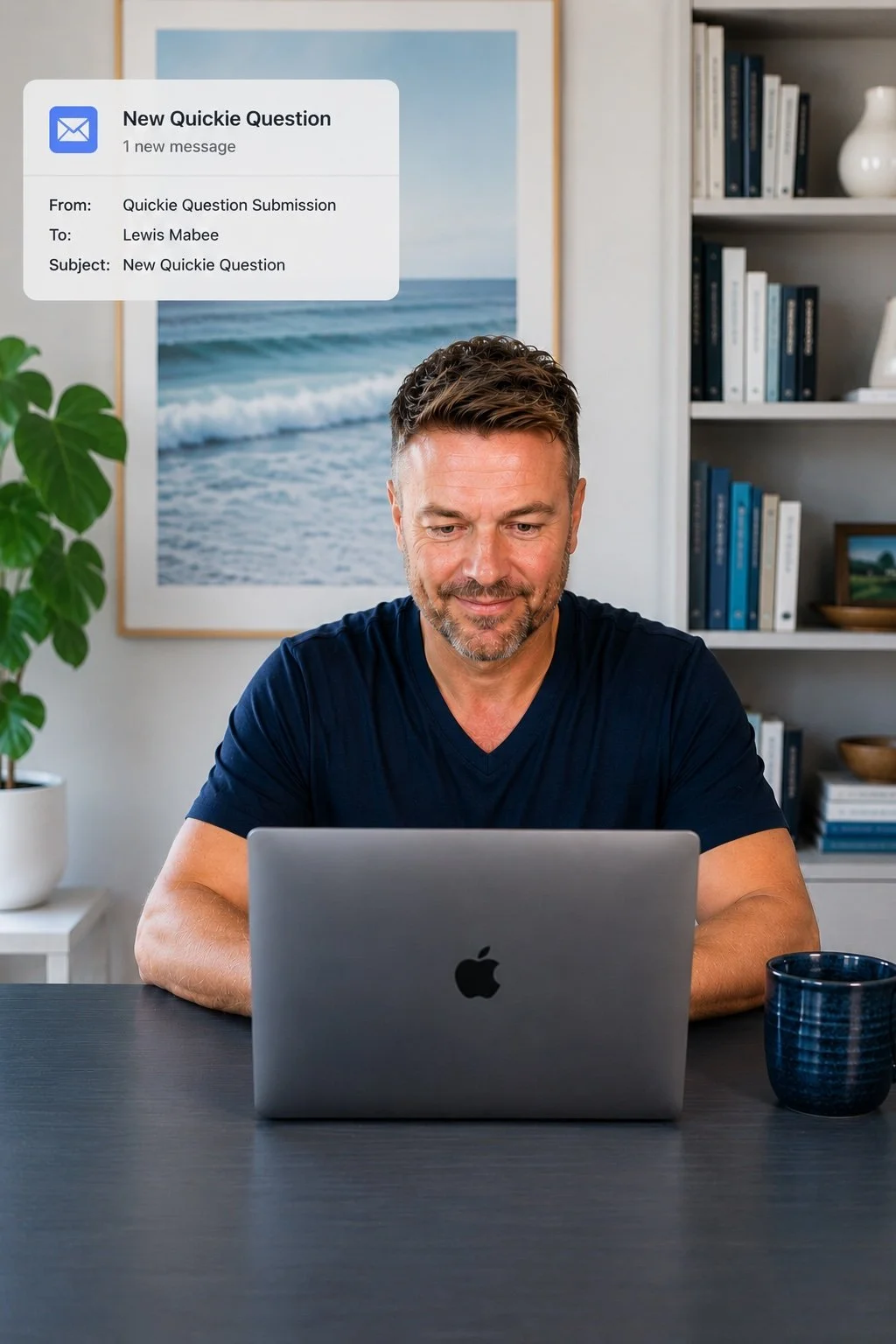 Lewis Mabee reviewing a new Quickie Question email submission on his MacBook, providing focused psychic insight and intuitive guidance through his email reading service from his home office.