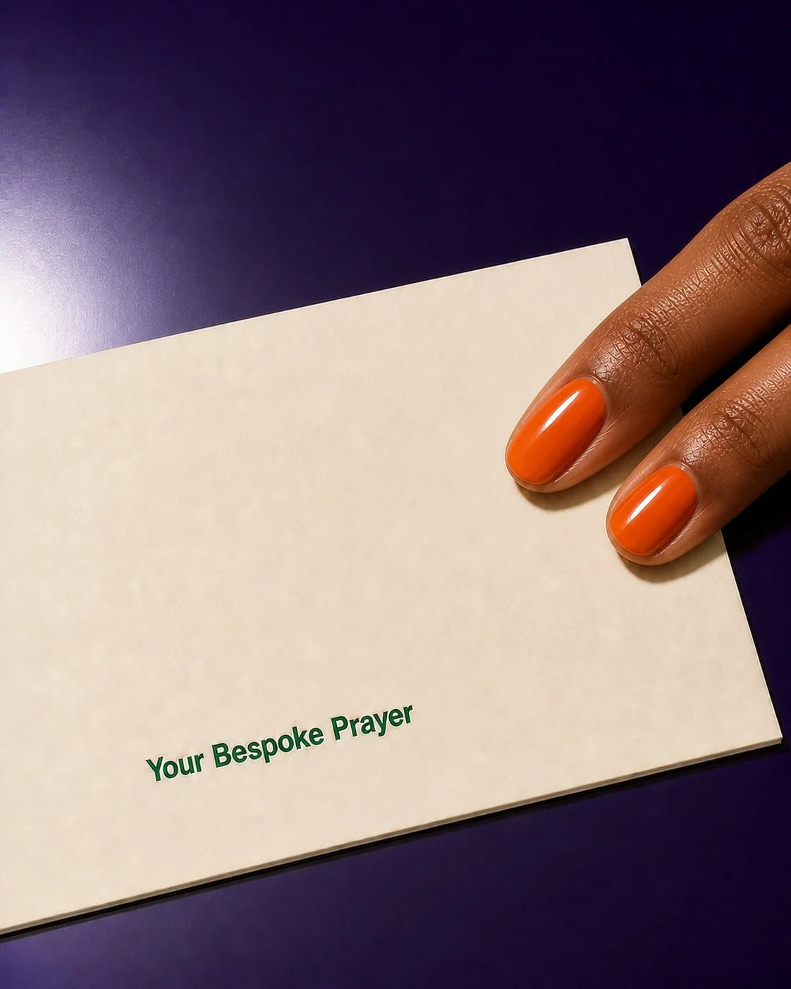 Orange-manicured fingertips resting on an ivory folded letter embossed with “Your Bespoke Prayer” against a glossy purple background.