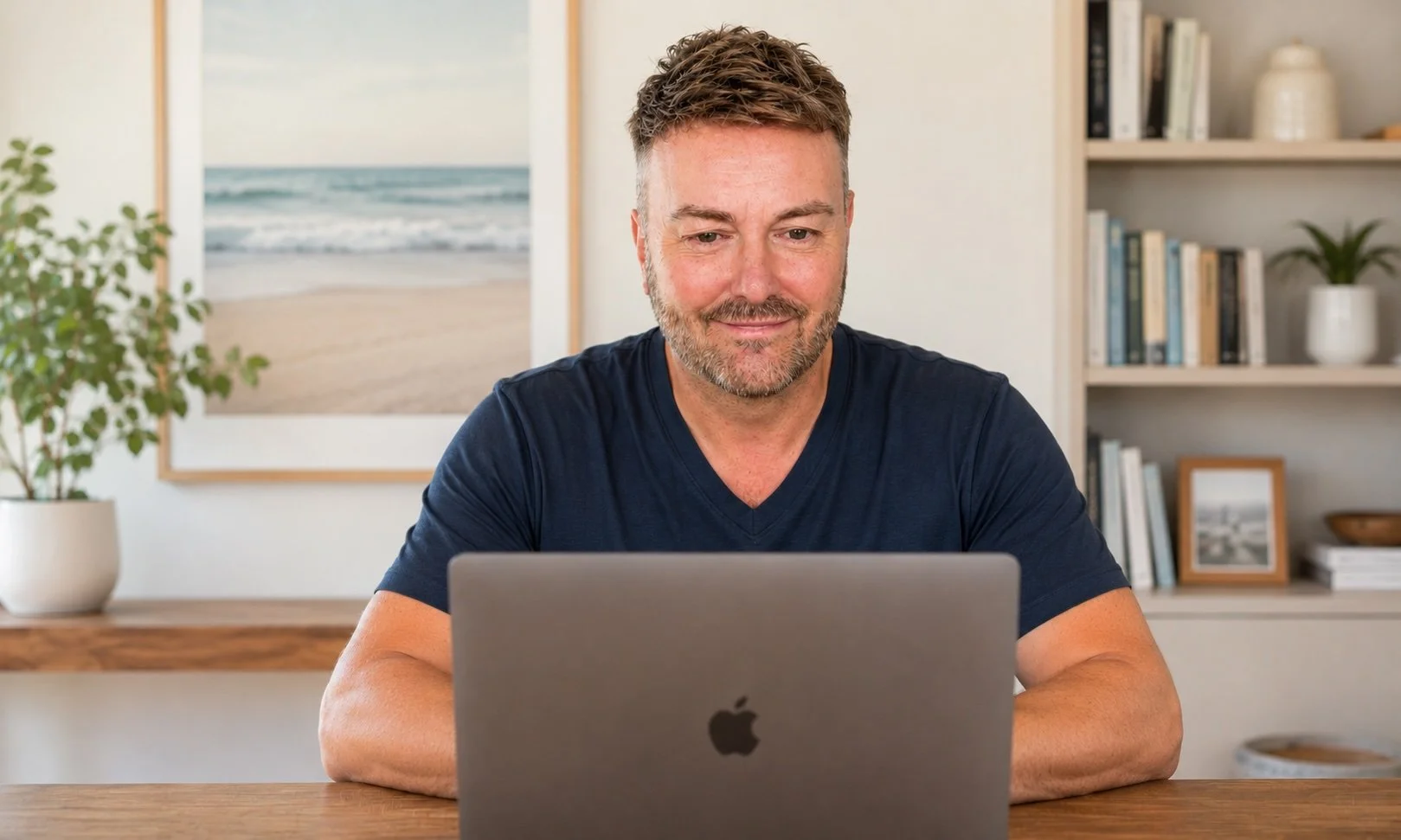 Lewis Mabee conducting an online psychic reading from his home office, engaged in conversation with a client through his MacBook Pro while providing intuitive guidance and support.