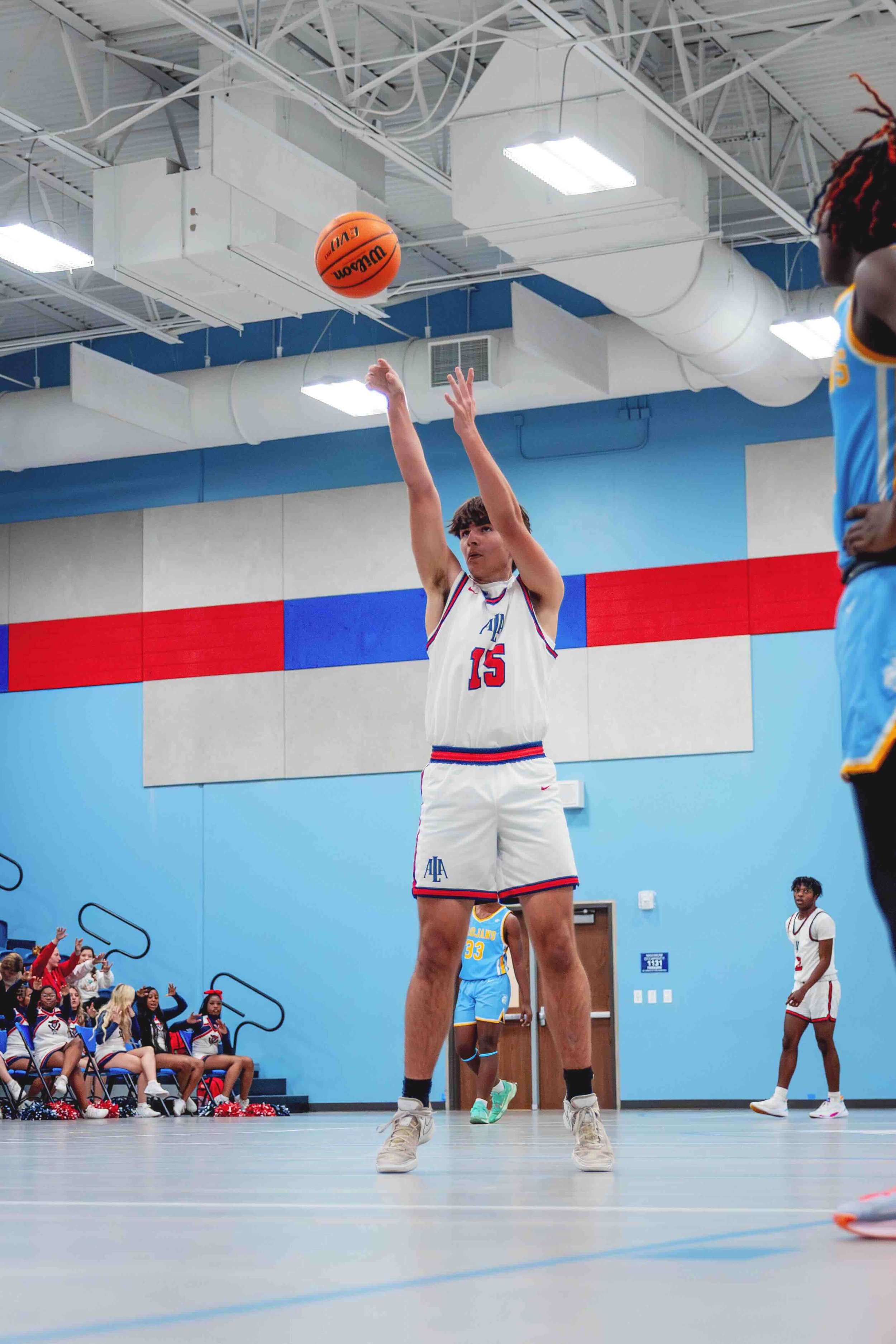 Basketball player shooting free throw in indoor court
