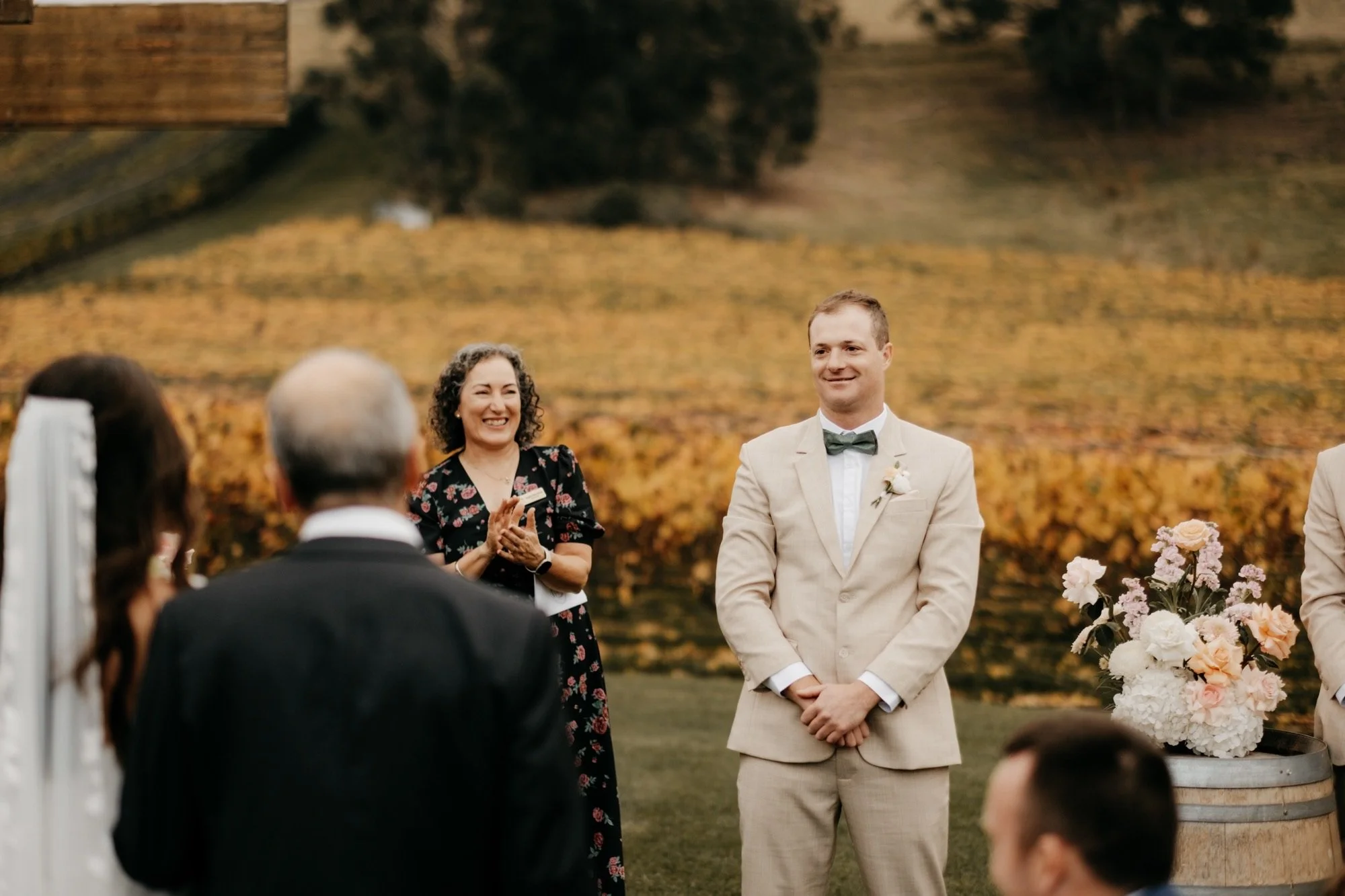 A wedding ceremony outdoors with a bride and groom at a winery/vineyard in Tasmania (Homehill winery)