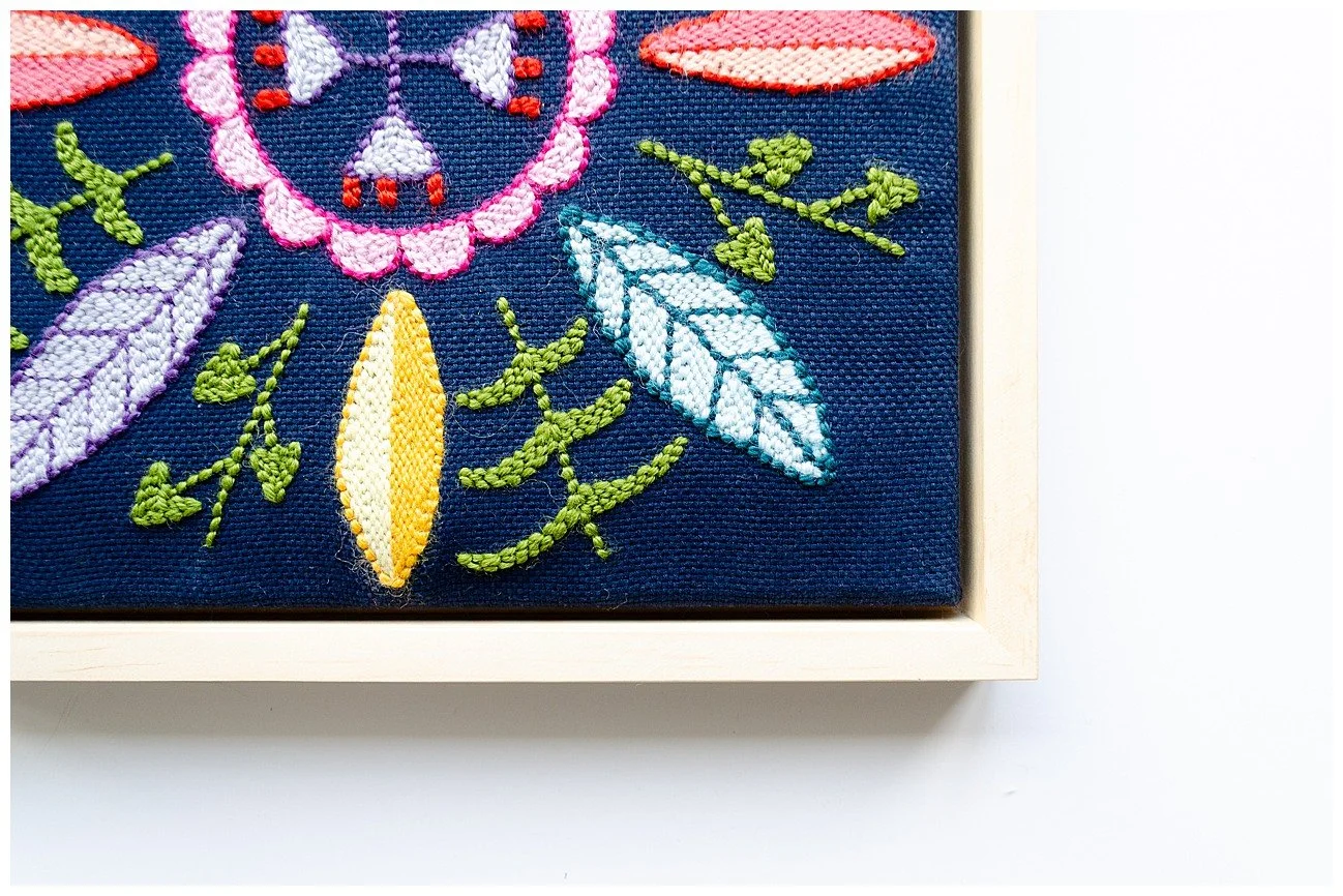 Detail of a punch needle textile artwork featuring contemporary Niuean hiapo-inspired motifs in colourful New Zealand wool.