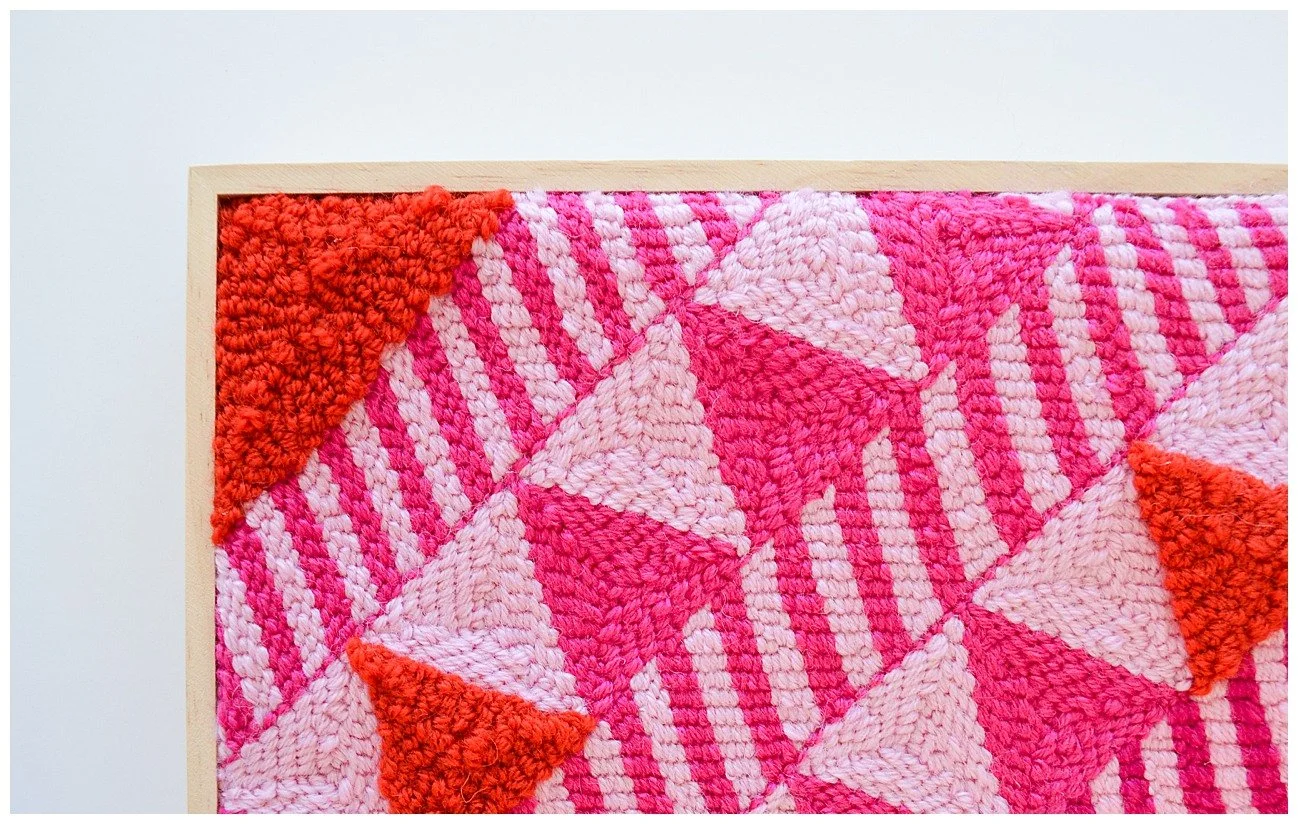 Punch needle textile artwork featuring contemporary Niuean hiapo-inspired motifs in colourful New Zealand wool.