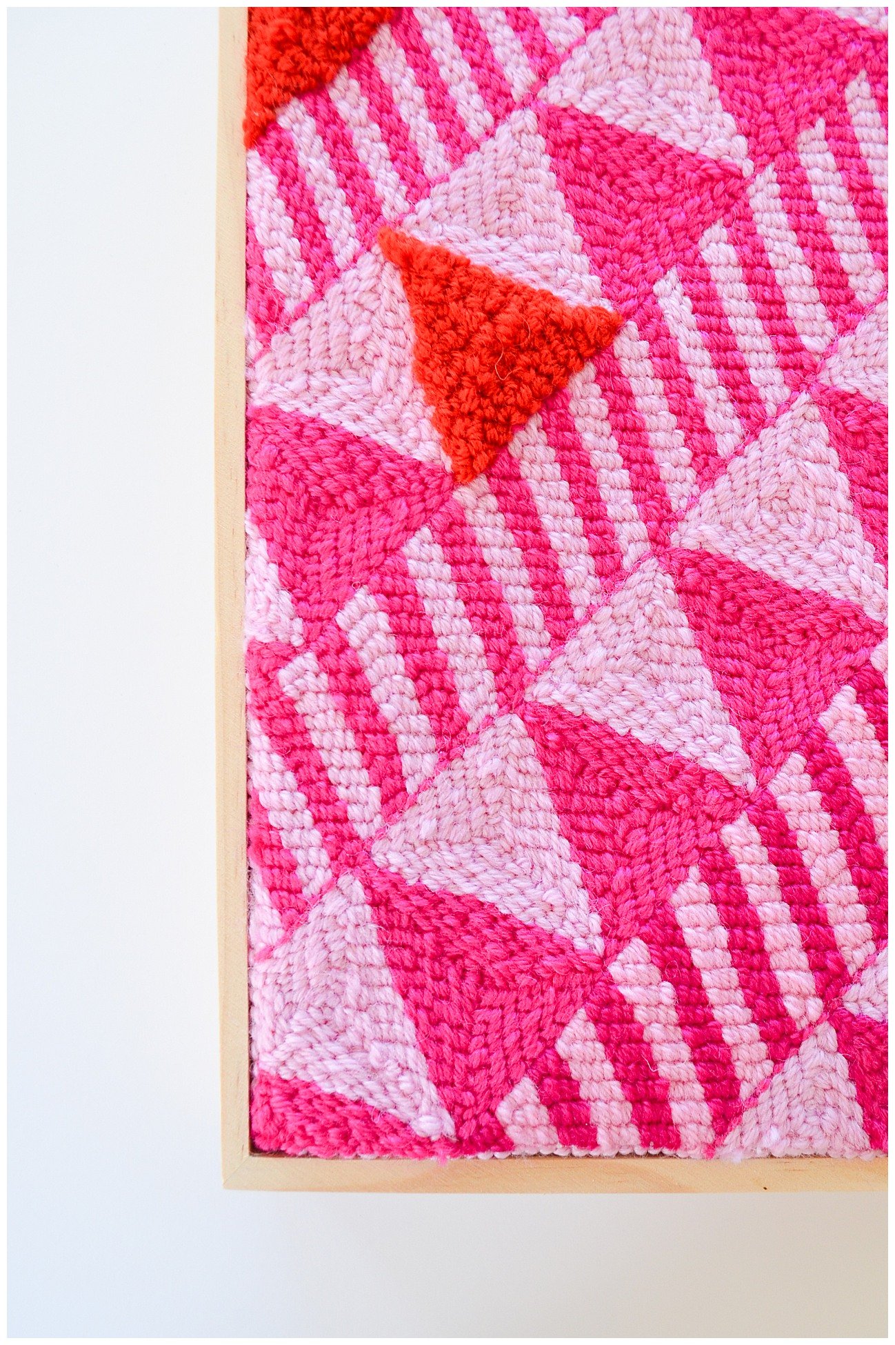 Punch needle textile artwork featuring contemporary Niuean hiapo-inspired motifs in colourful New Zealand wool.