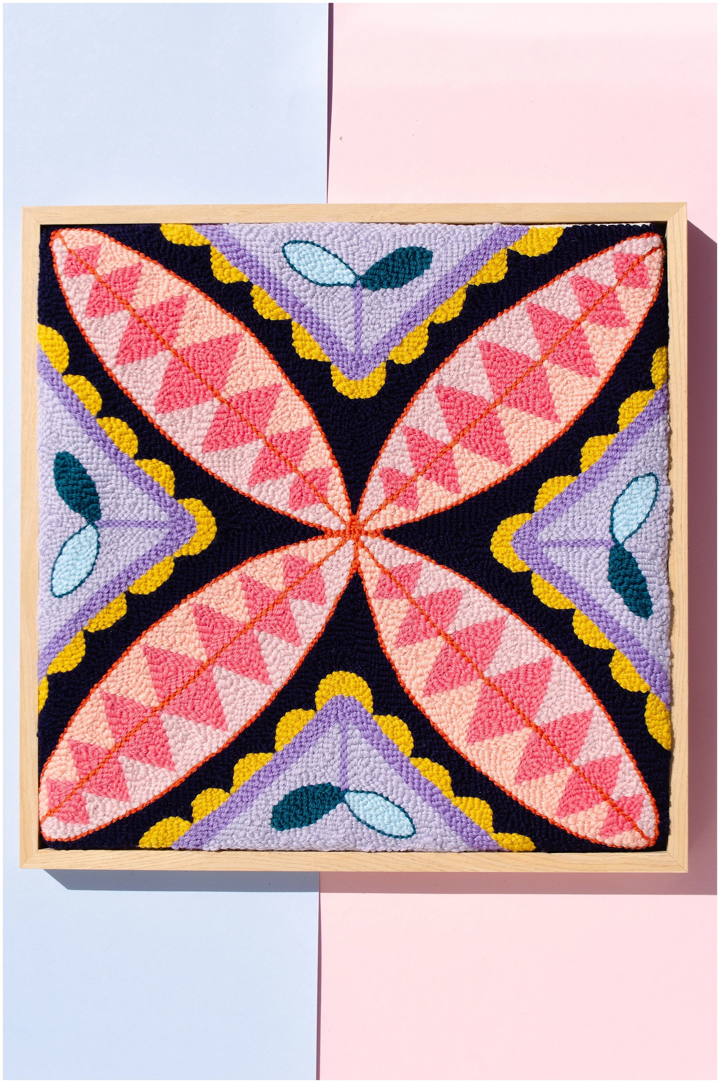 Punch needle textile artwork featuring contemporary Niuean hiapo-inspired motifs in colourful New Zealand wool.