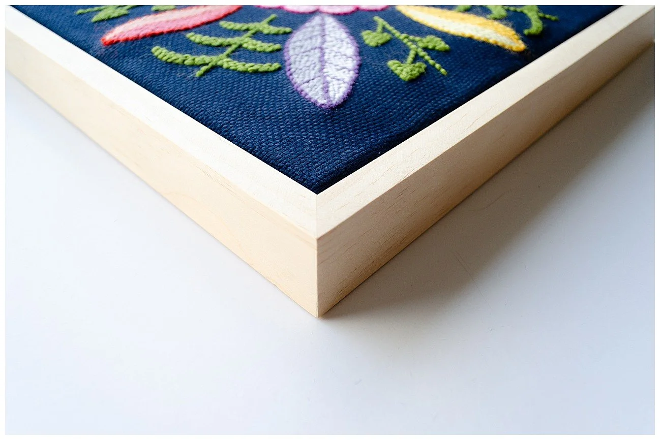 Detail of a punch needle textile artwork featuring contemporary Niuean hiapo-inspired motifs in colourful New Zealand wool.