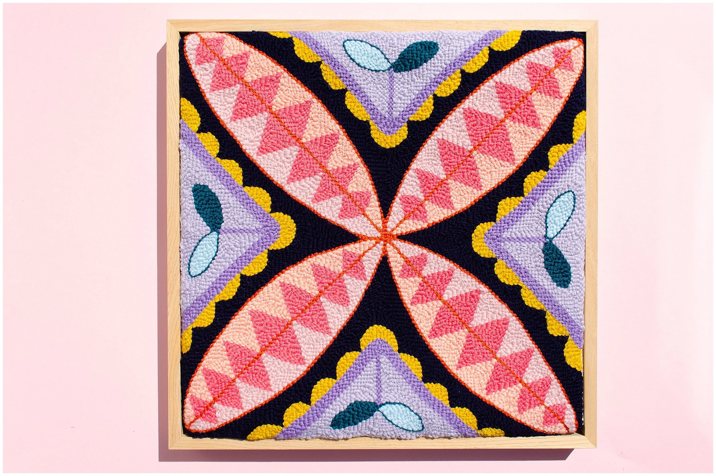 Punch needle textile artwork featuring contemporary Niuean hiapo-inspired motifs in colourful New Zealand wool.