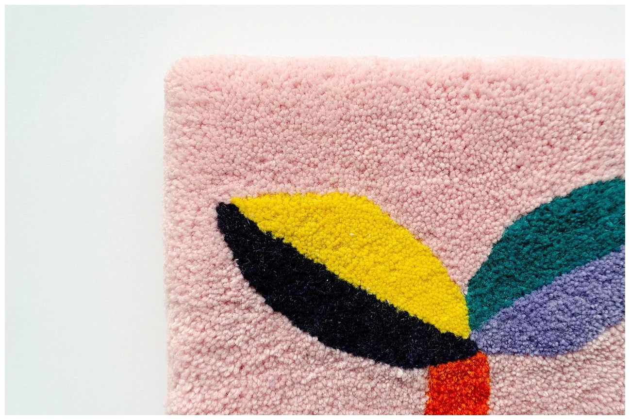 Detail of tufted wool textile showcasing fine Pacific-inspired pattern work and texture.