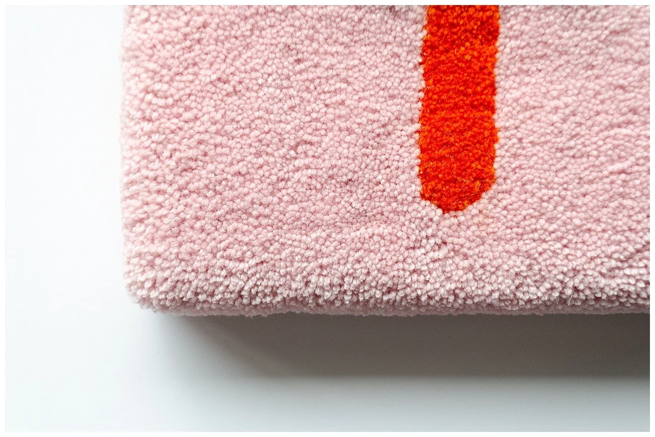 Detail of tufted wool textile showcasing fine Pacific-inspired pattern work and texture.