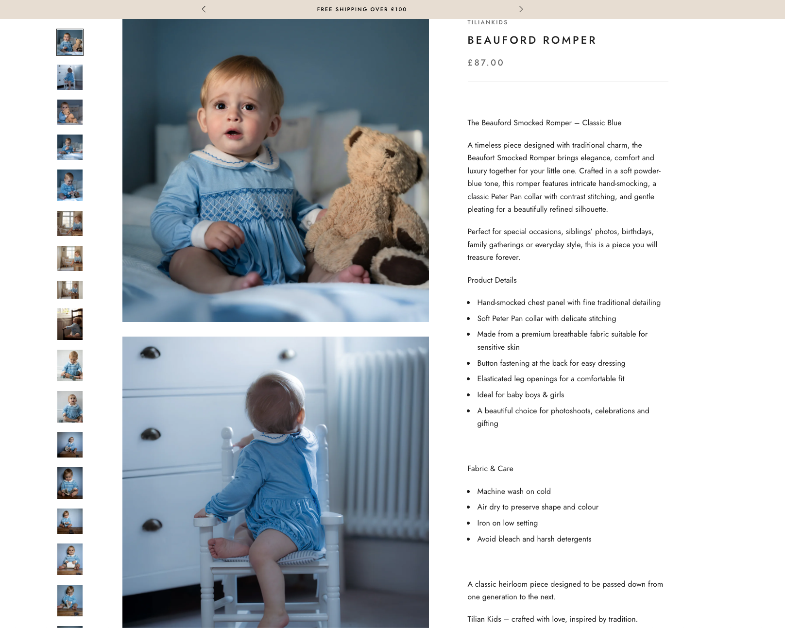 Two young children wearing blue pajamas, one sitting on a bed with a teddy bear, and the other sitting on a small white chair facing a white dresser with drawers.