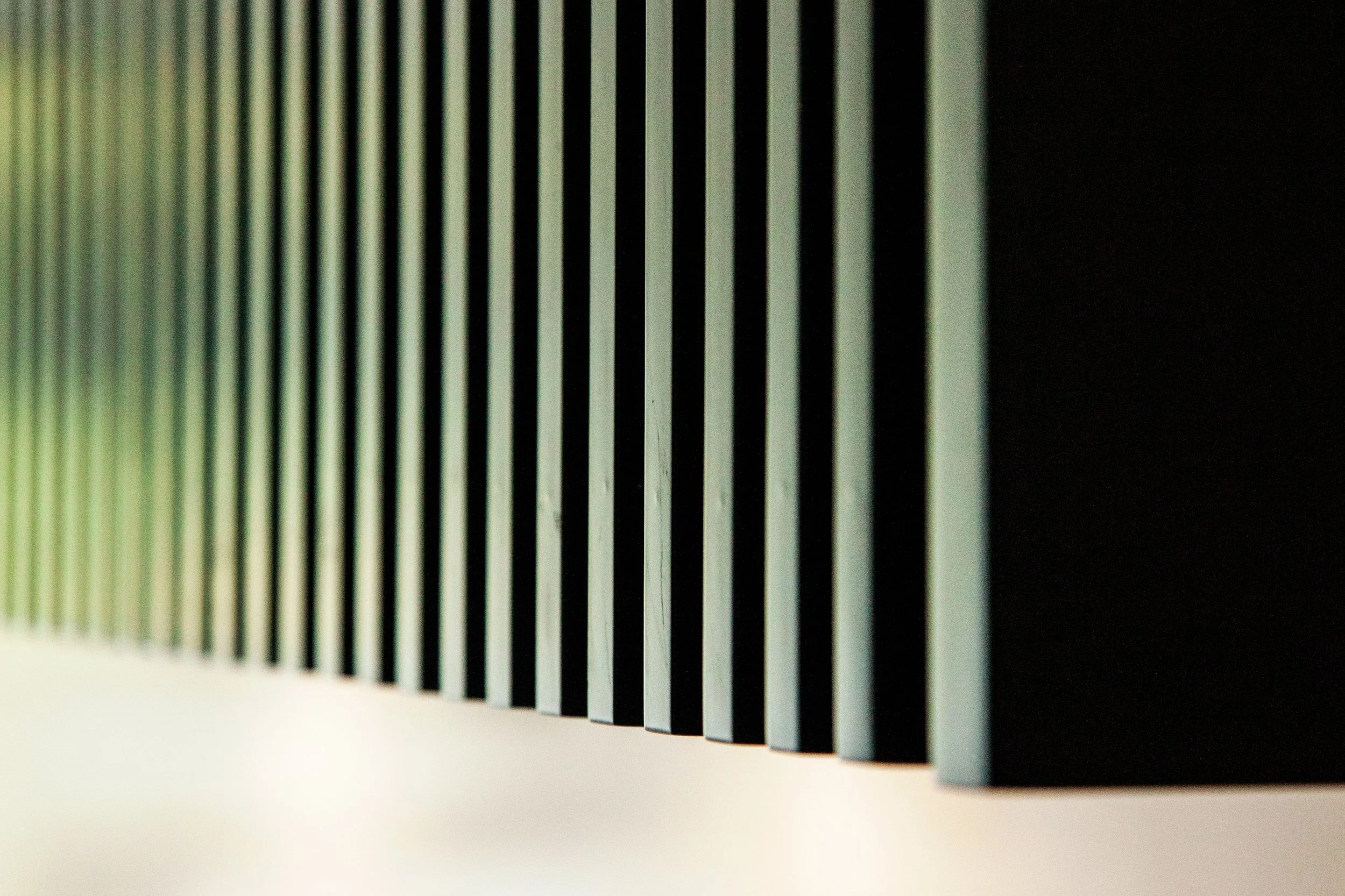 Close-up of a stack of playing cards with a white and black back design, arranged vertically.