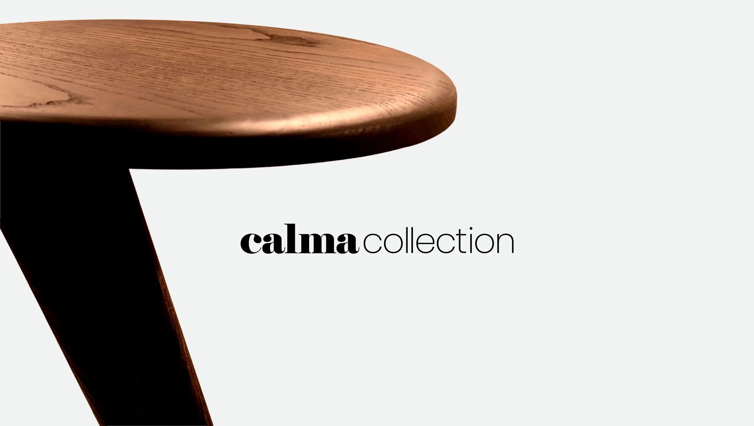 Close-up of a wooden table leg with the words 'calma collection' on a light background