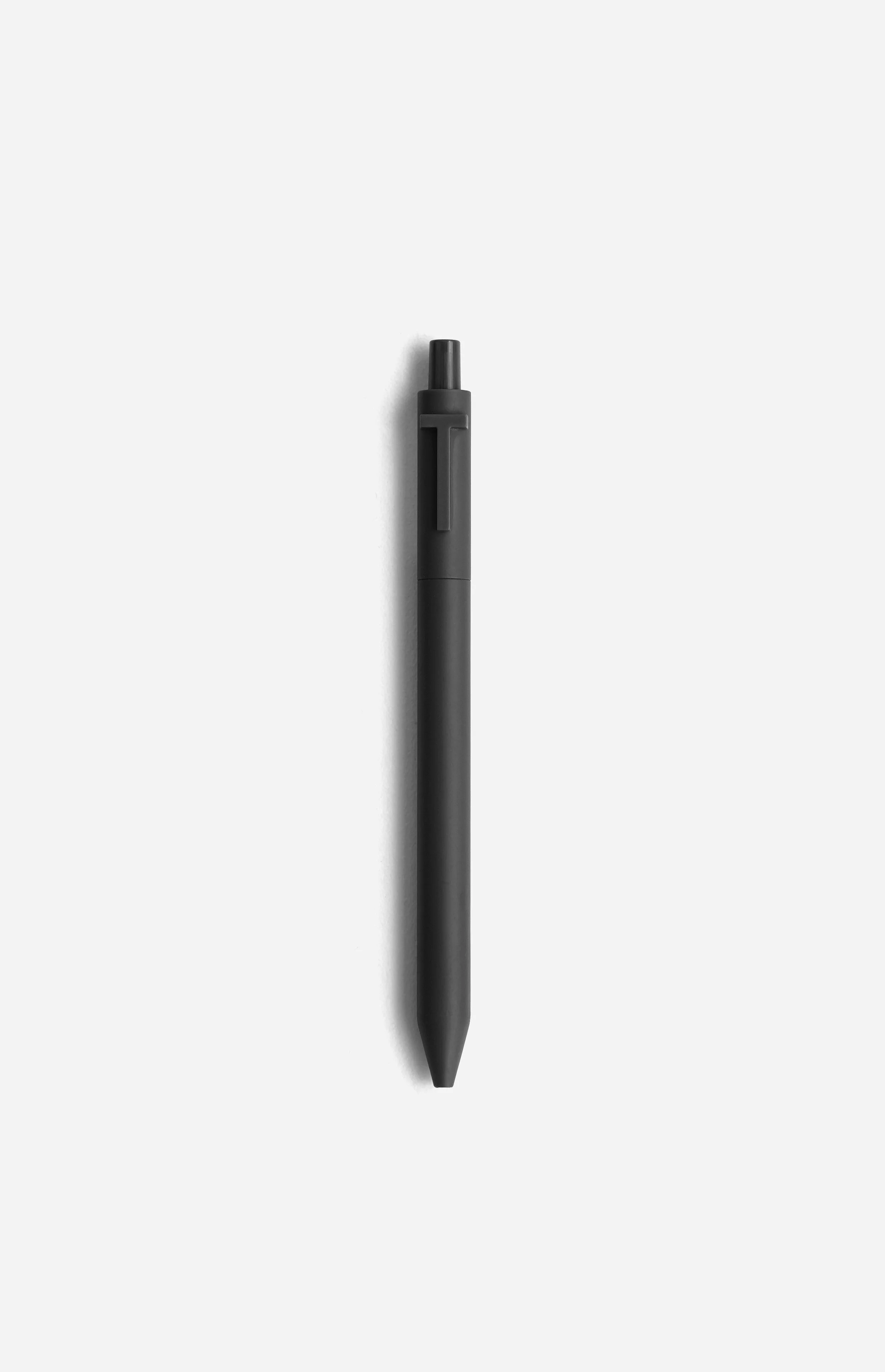 A black pen with a clip on the cap, placed on a white background.