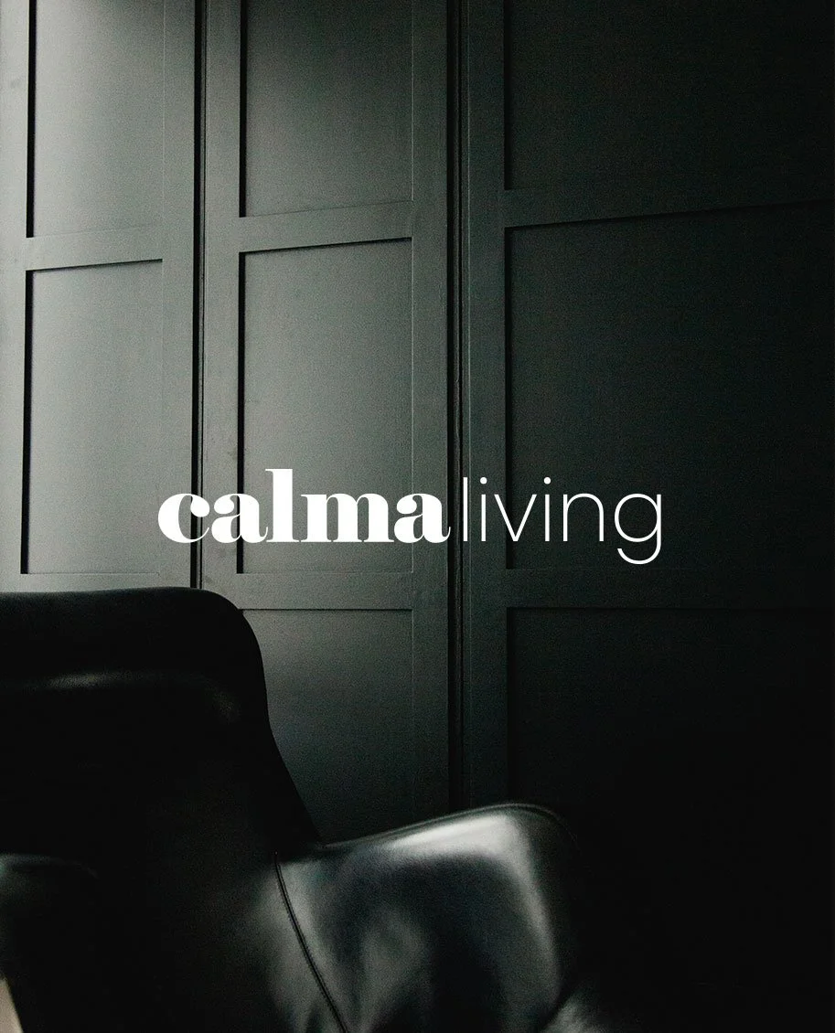 Dark interior scene with black paneling and leather chairs, with the words 'calm living' overlaid.