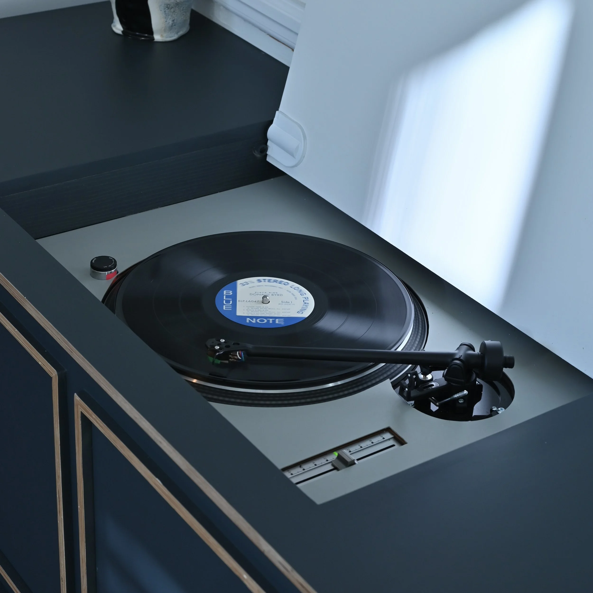 Turntable playing a vinyl record in a modern setting.