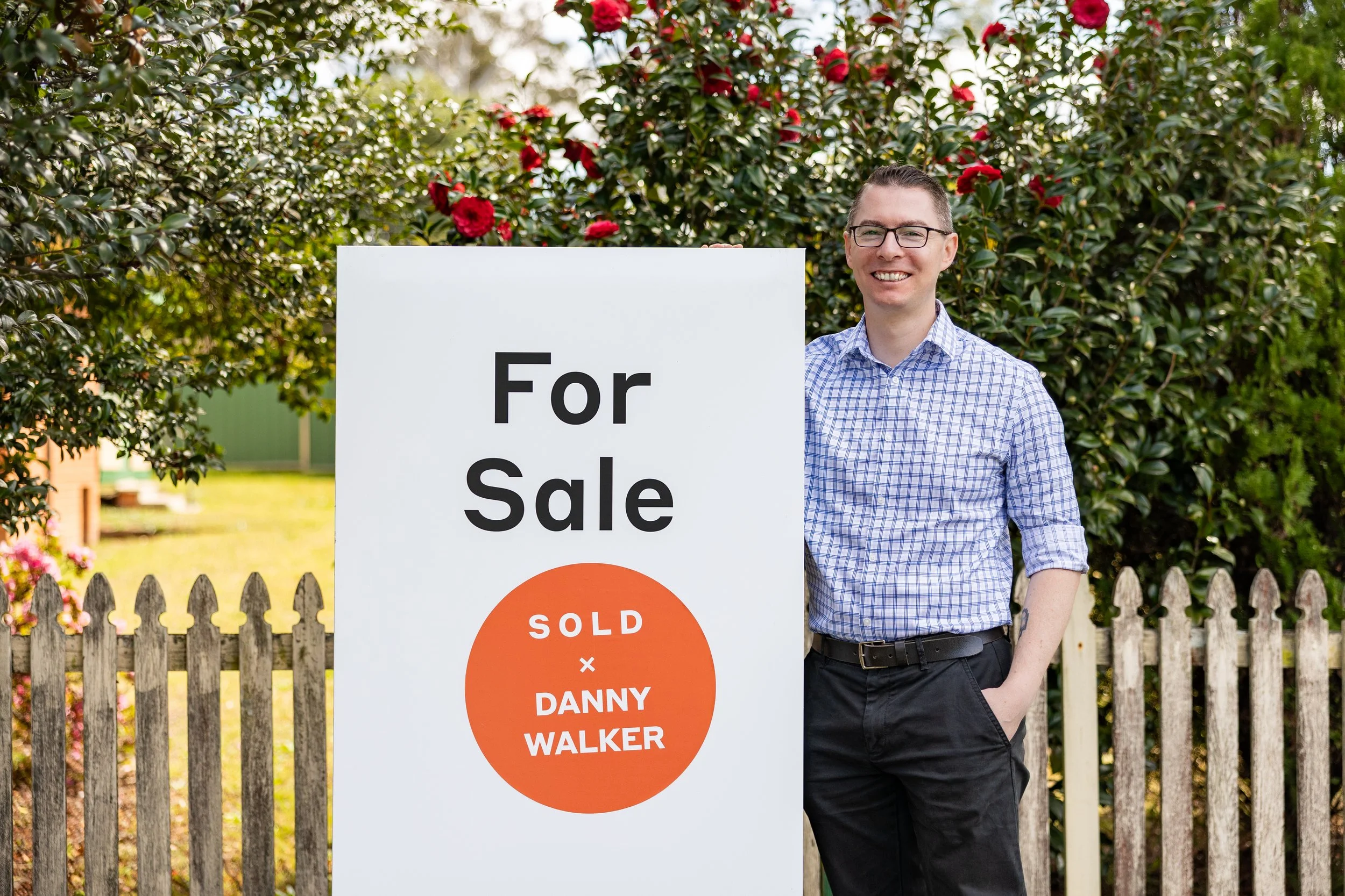 Danny Walker standing beside a sold sign in Blaxland NSW, celebrating another successful local property sale with Danny Walker Real Estate.