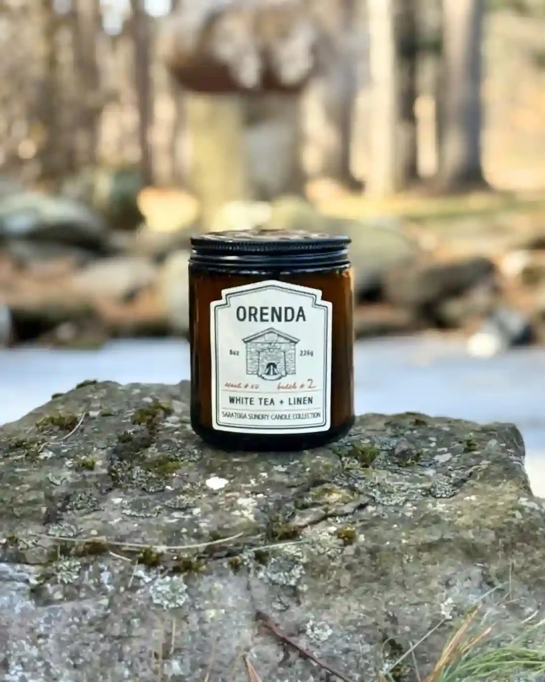 Orenda Saratoga Sundry candle on a rock.webp