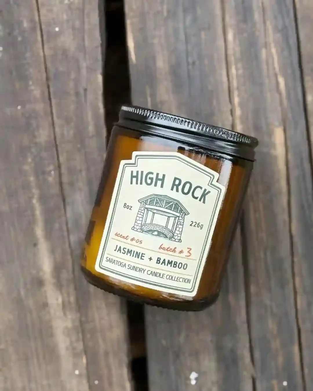 High Rock candle from Saratoga Sundry sitting on a wooden antique crate.webp