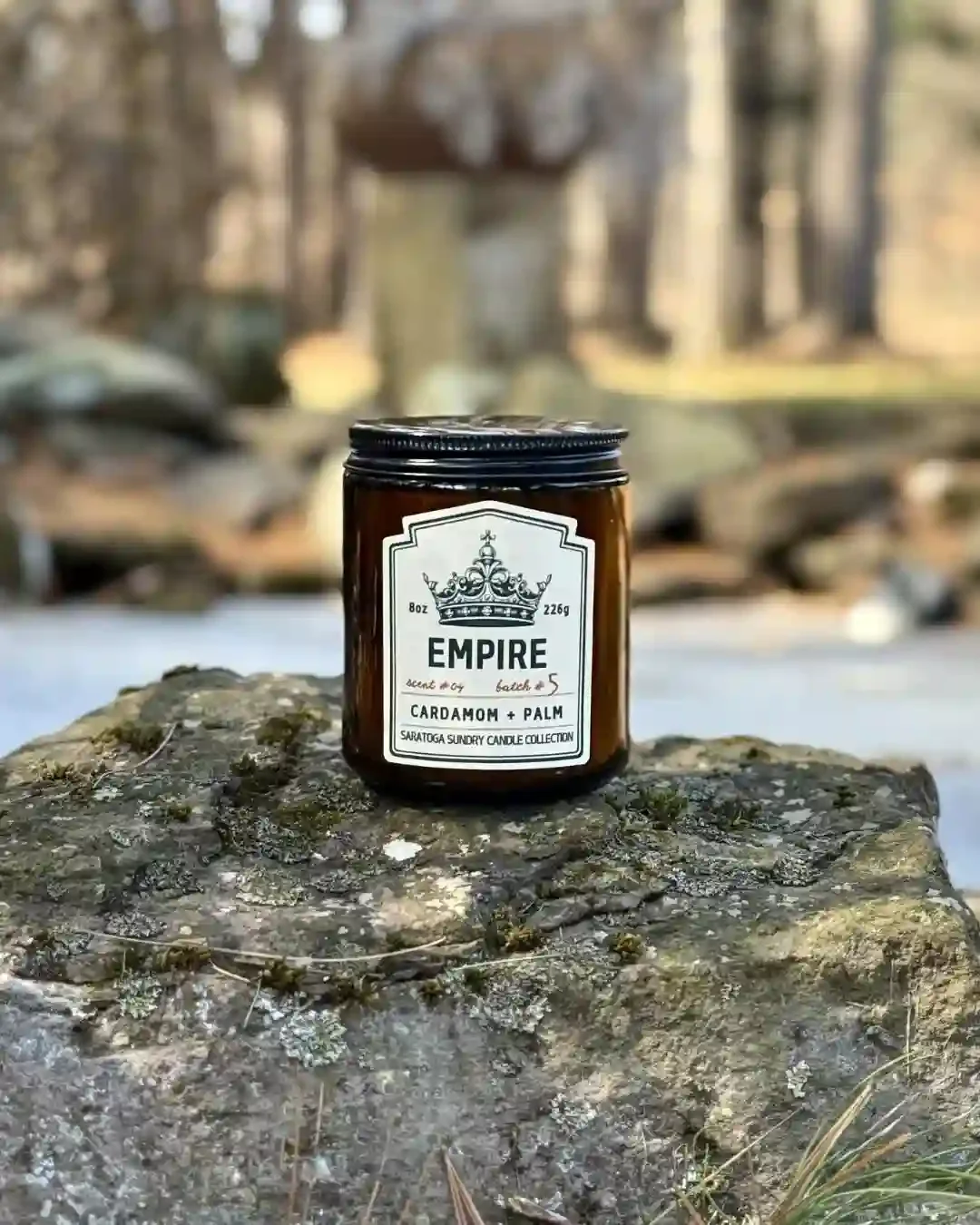 Empire Saratoga Sundry candle on a rock.webp