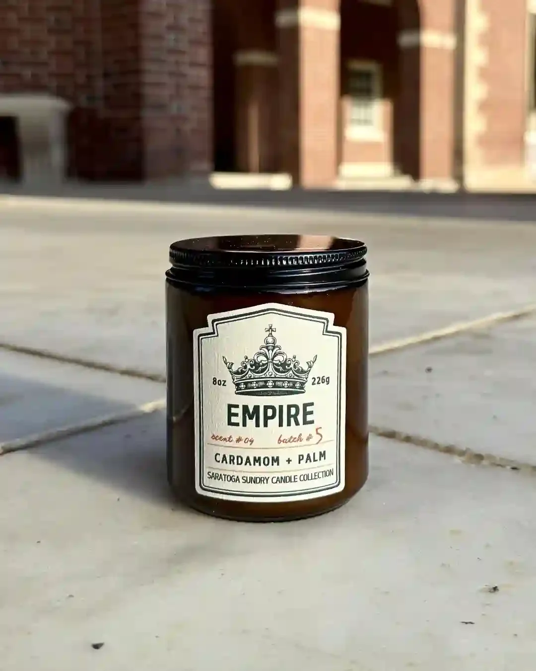 Empire soy candle in amber jar from Saratoga Sundry set in the Hall of Springs.webp