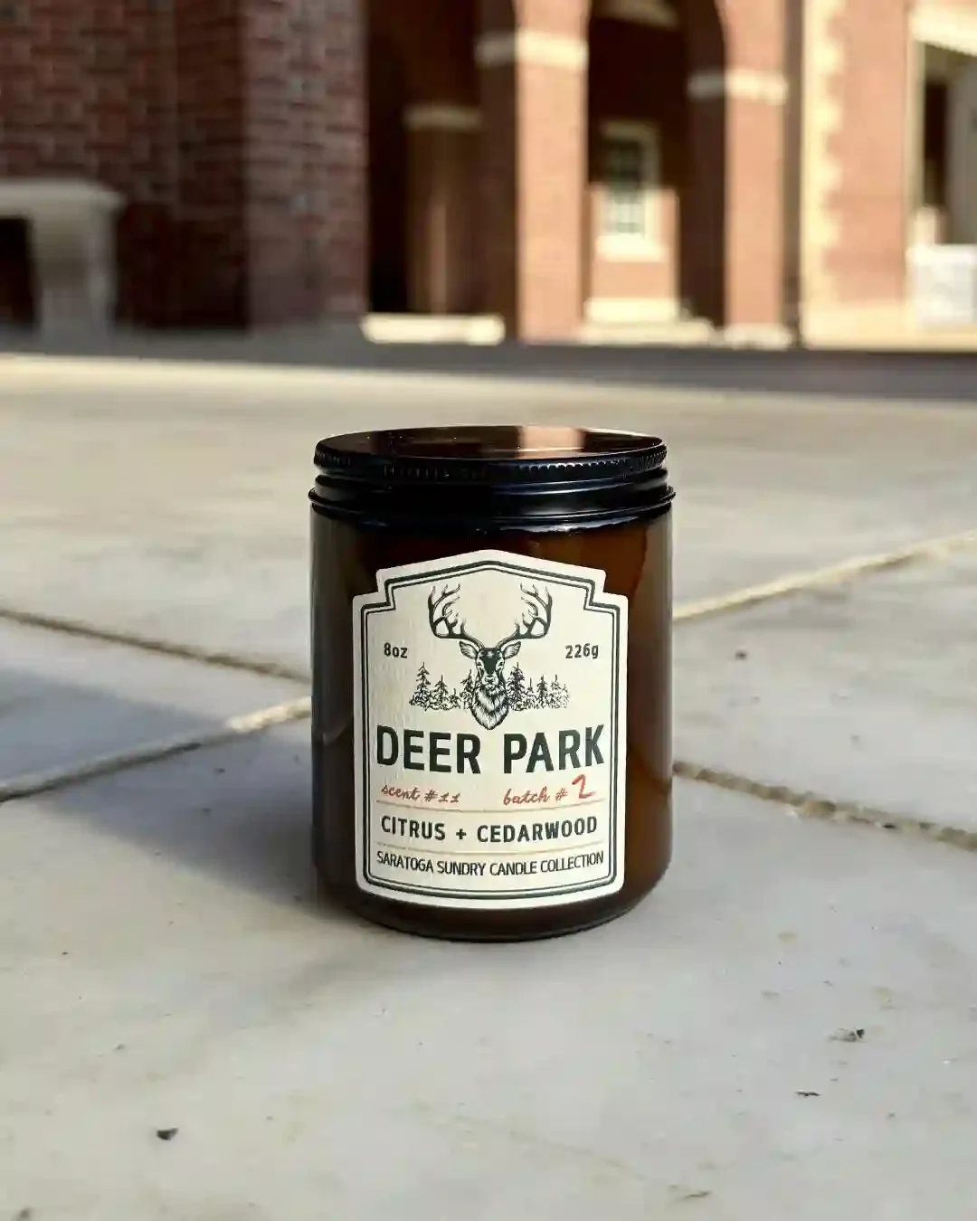 Deer Park soy candle in amber jar from Saratoga Sundry set in the Hall of Springs.webp