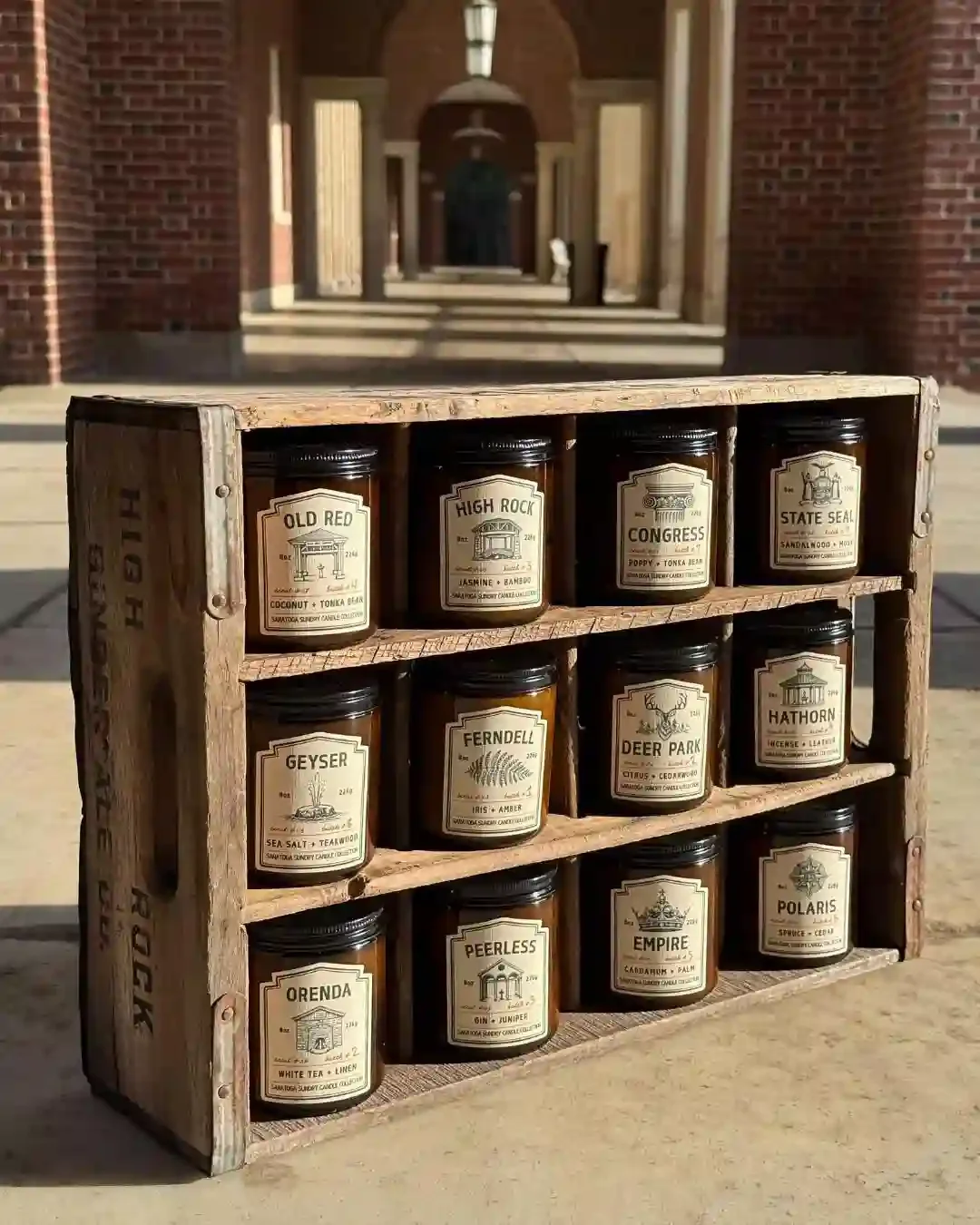 Collection of Saratoga Sundry joy candles in amber jars in the Hall of Springs in crate.webp