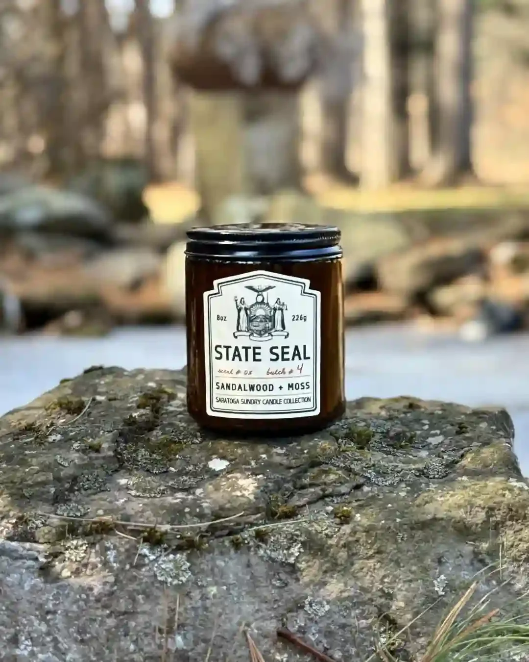State Seal Saratoga Sundry candle on a rock.webp