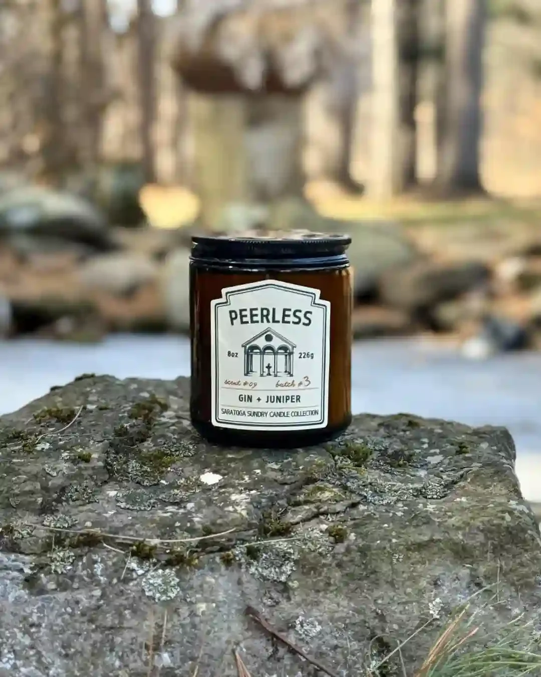 Peerless Saratoga Sundry candle on a rock.webp