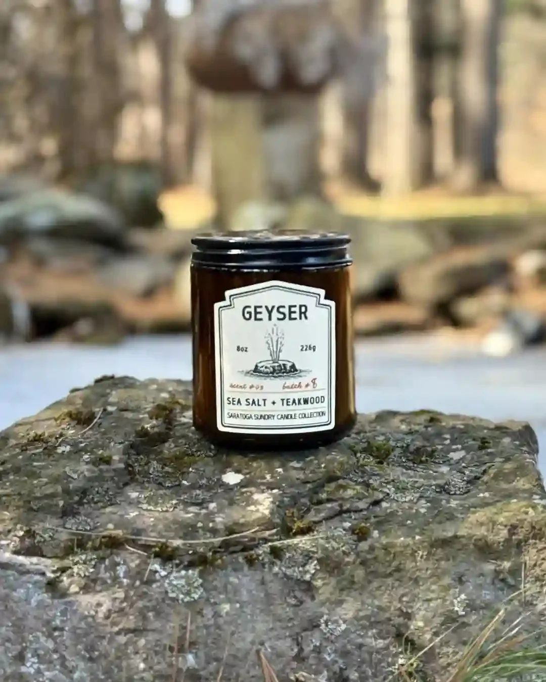 Geyser Saratoga Sundry candle on a rock.webp