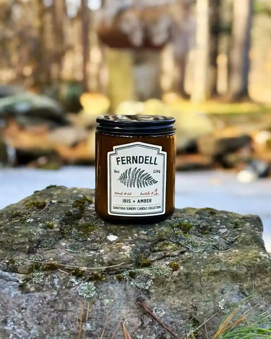 Ferndell Saratoga Sundry candle on a rock.webp