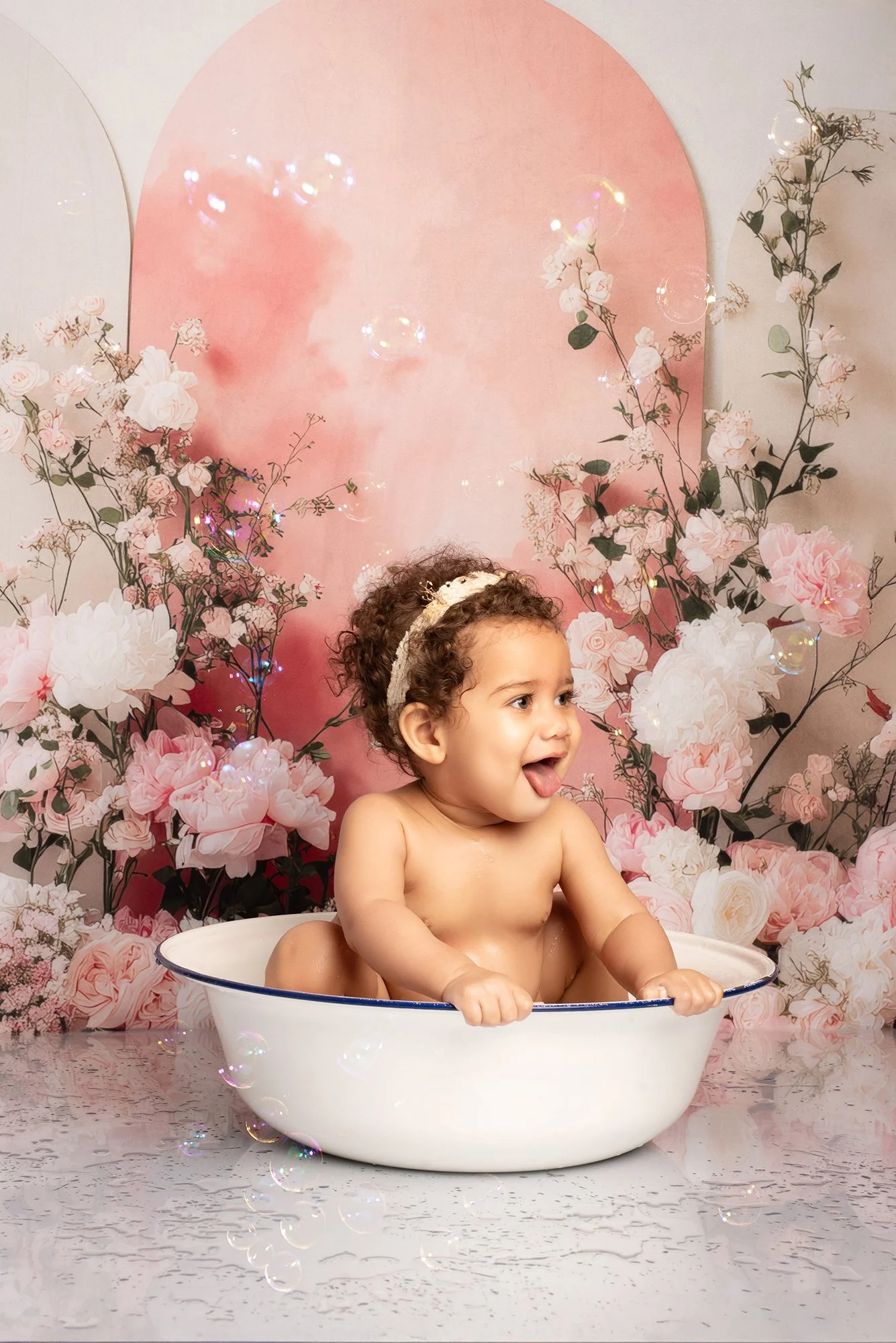 baby in a bath with floral background 