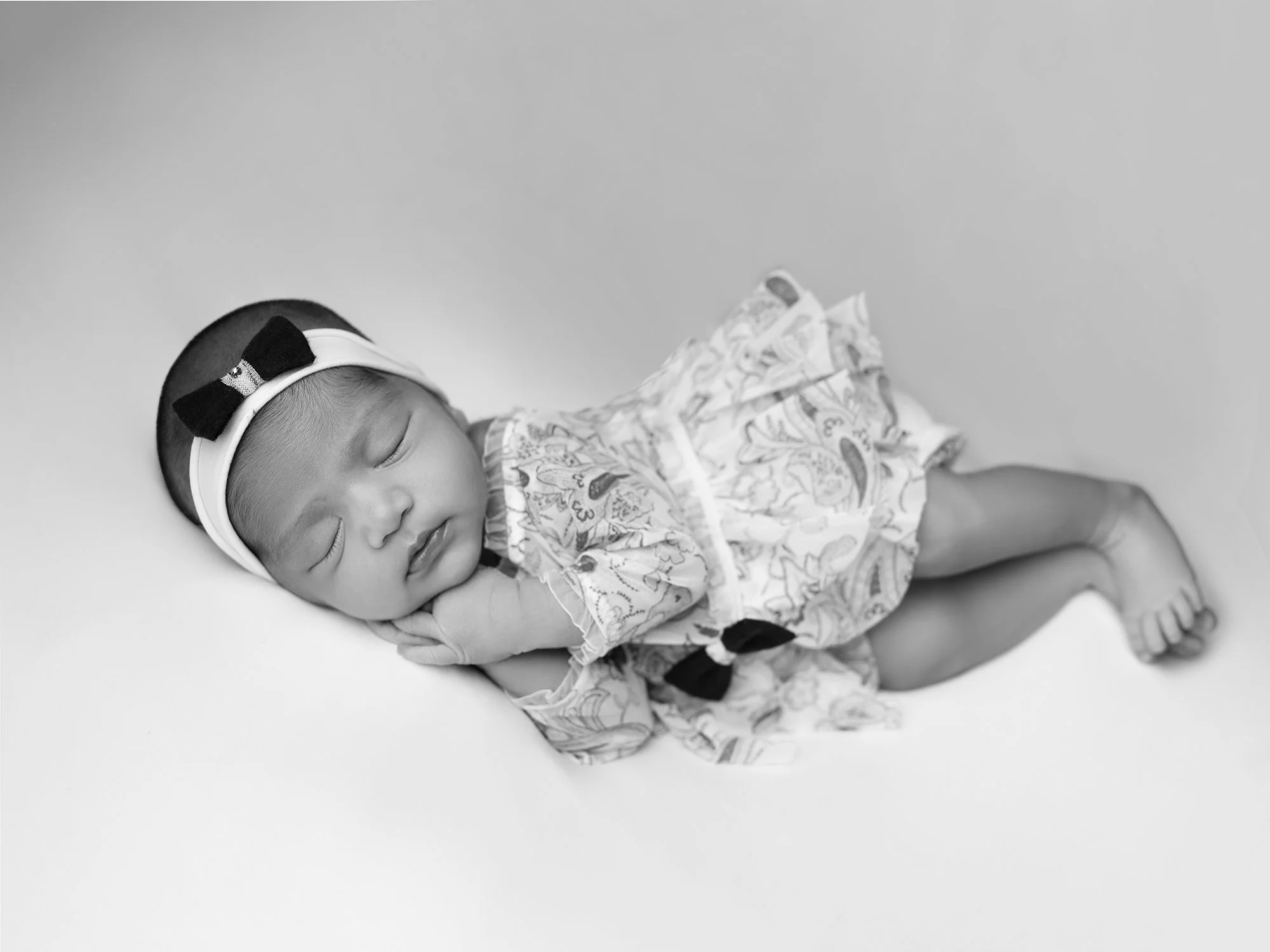 b&w picture of a newborn baby girl - side pose
