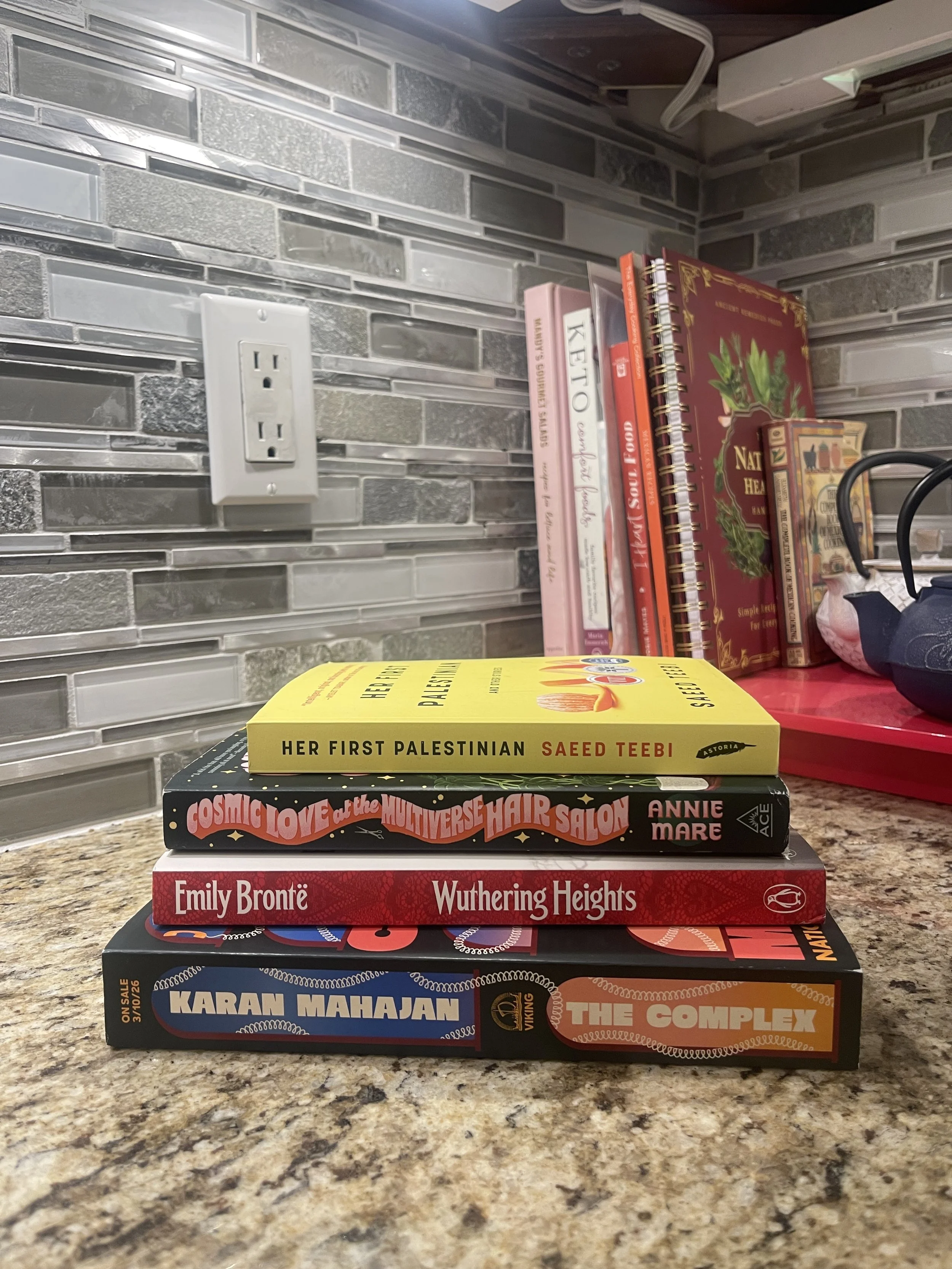 Photograph of books stacked on a kitchen counter
