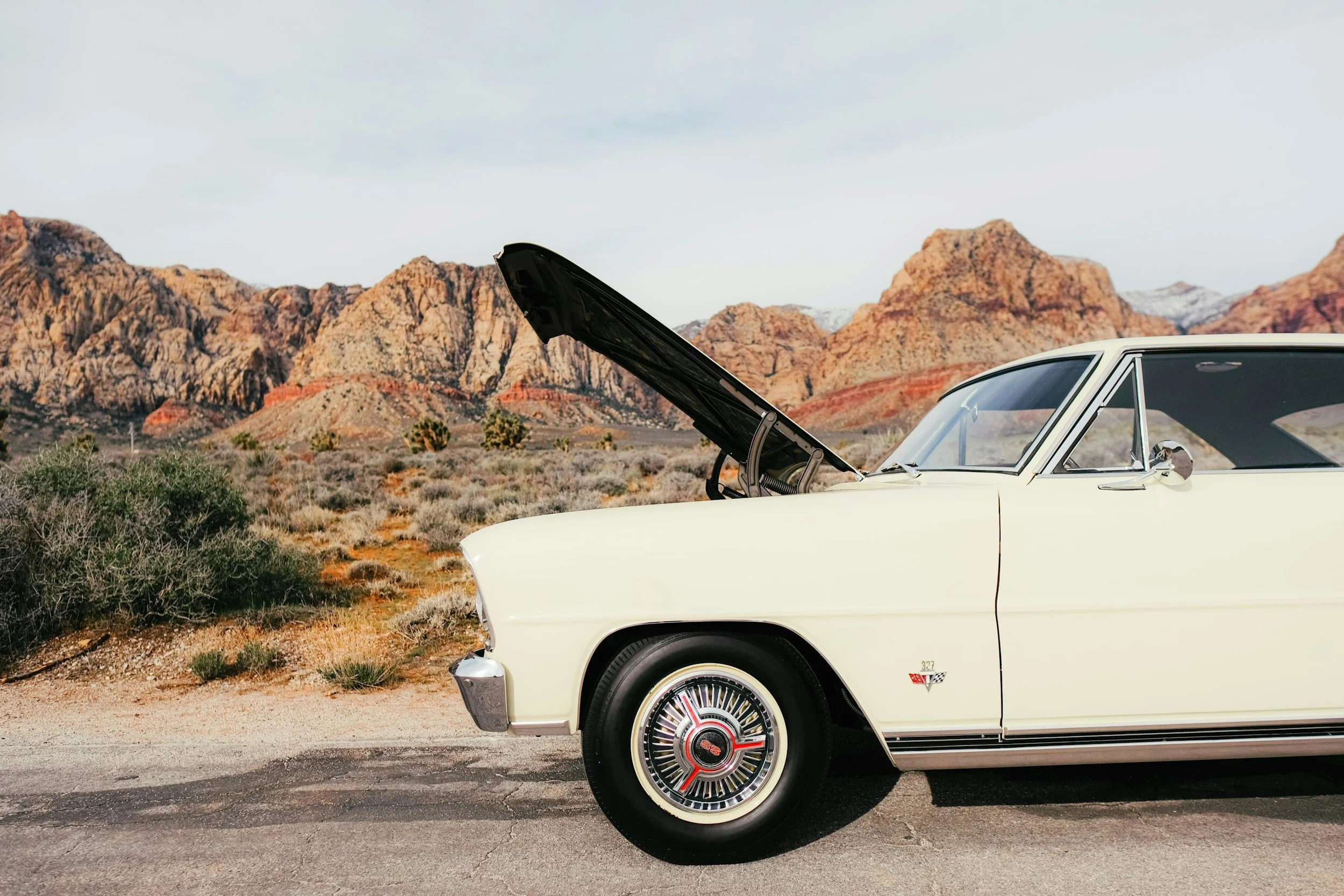 Vintage car on the side of the road with its hood up to symbolize when what used to work doesn't anymore