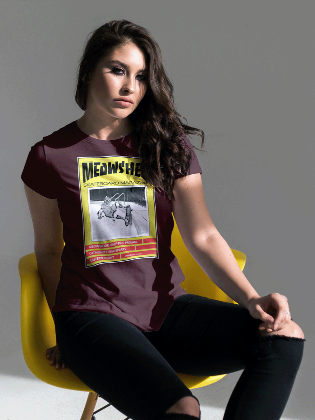 Model wearing a maroon Meowsher graphic T-shirt from The Meowlitia