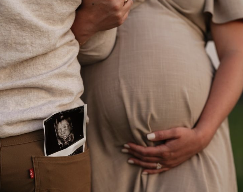 A couple revealing they are pregnant with a baby