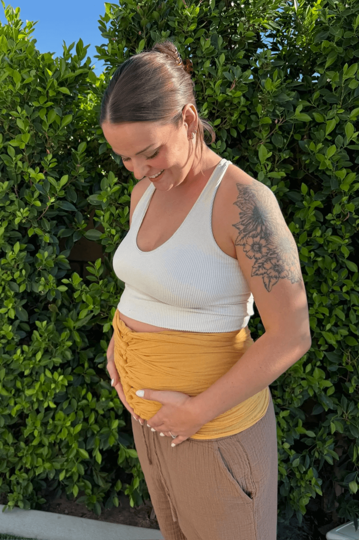 Working with Nurture The Divine, a postpartum women participates in belly binding in Riverside, CA.