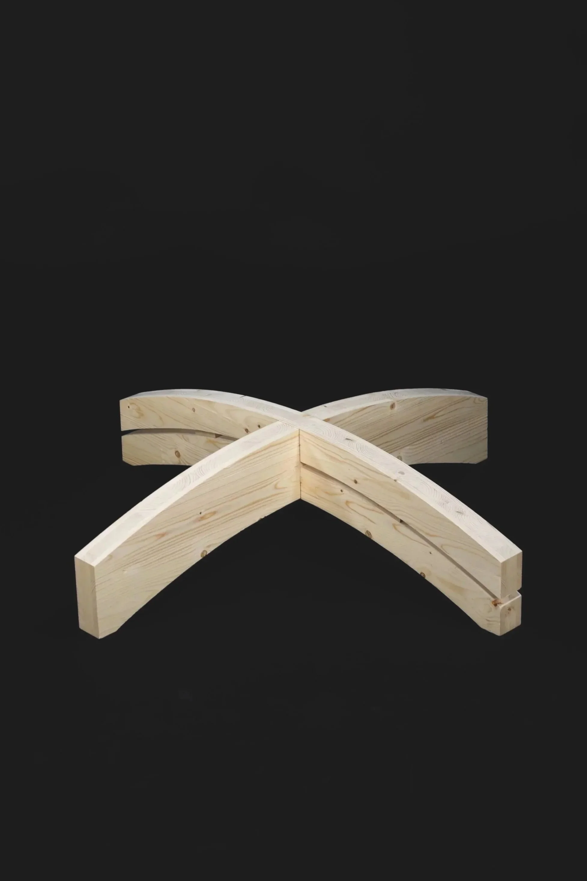 Two curved wooden beams crossed in an 'X' shape on a black background.
