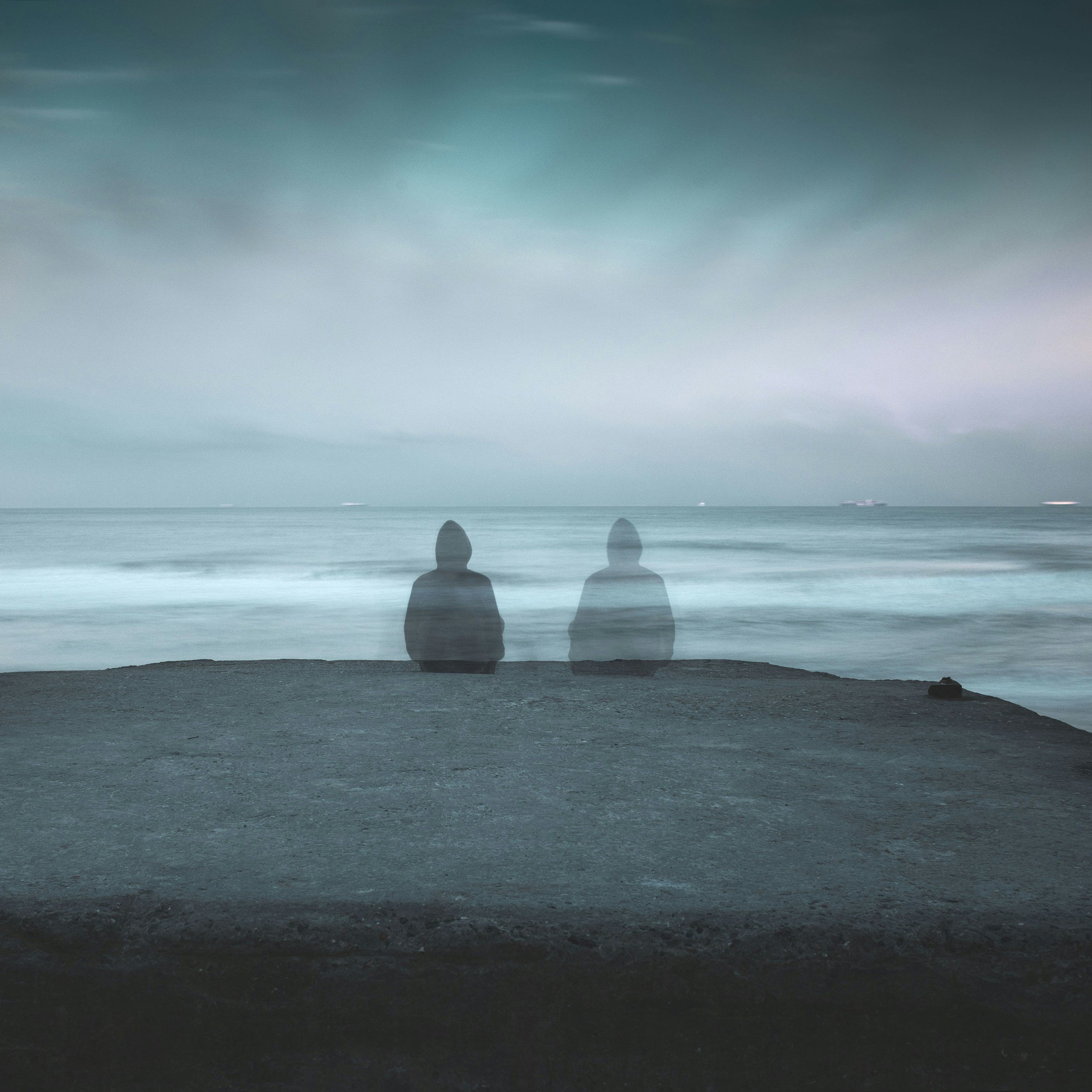 Blurred image someone sitting at the beach contemplative, representing complex trauma and emotional overwhelm before seeking trauma therapy San Diego.