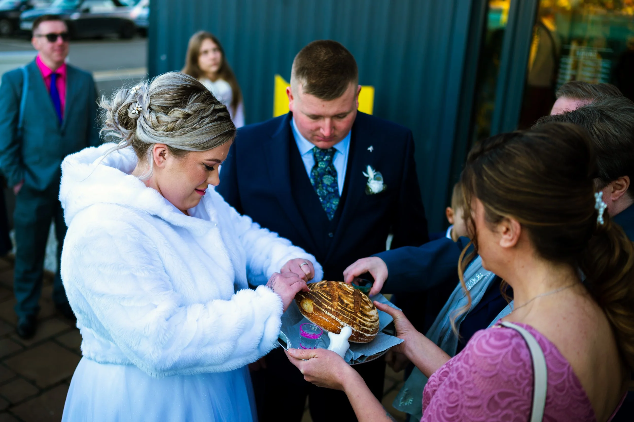 wedding reception restaurant dinner family members couple eating from the same bread polish tradition