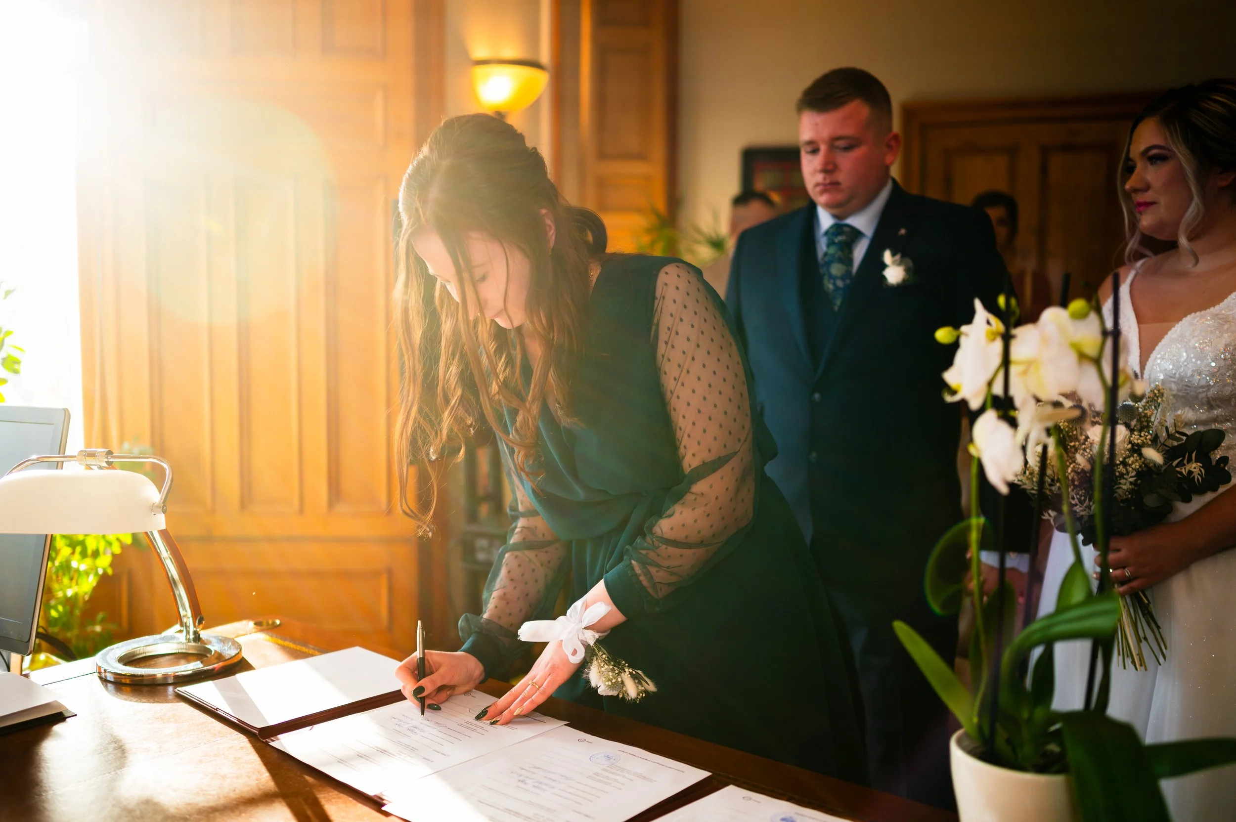 bride groom wedding ceremony family members signing papers