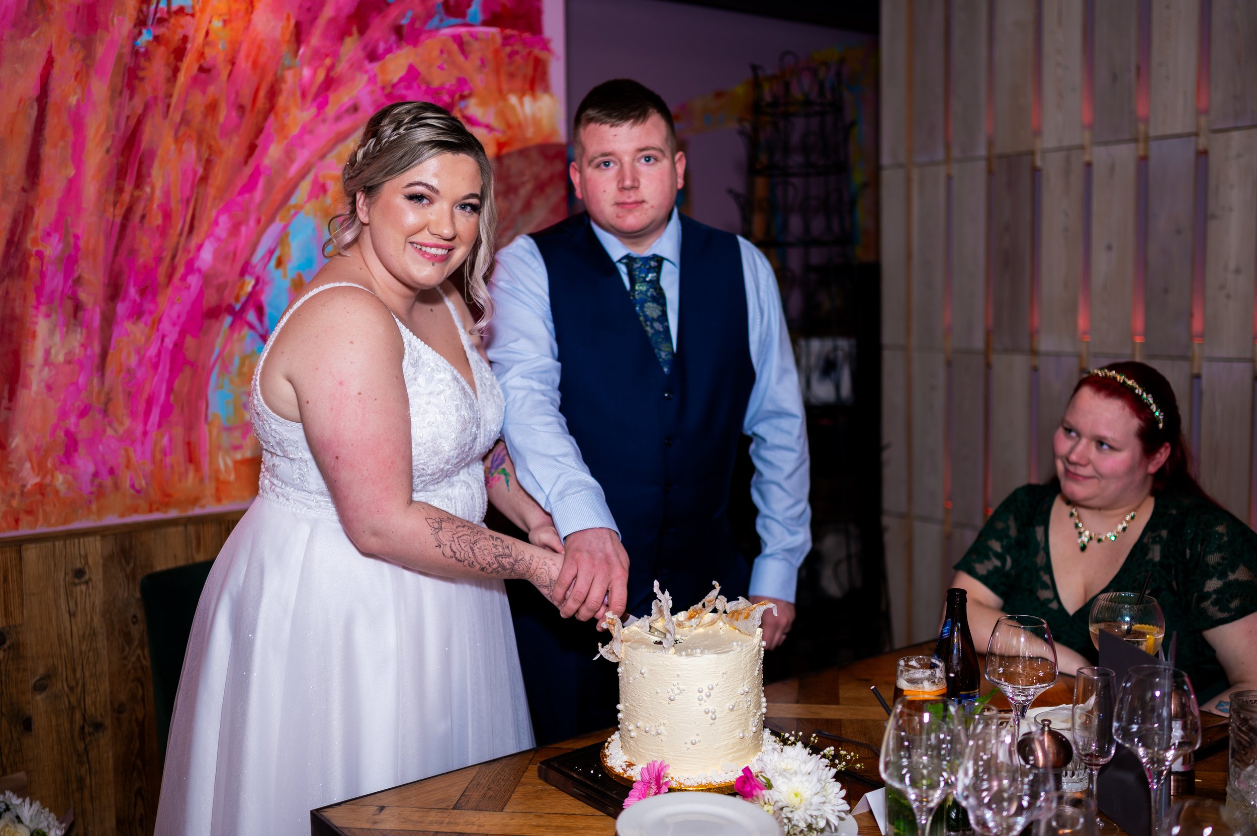 wedding reception couple cutting cake