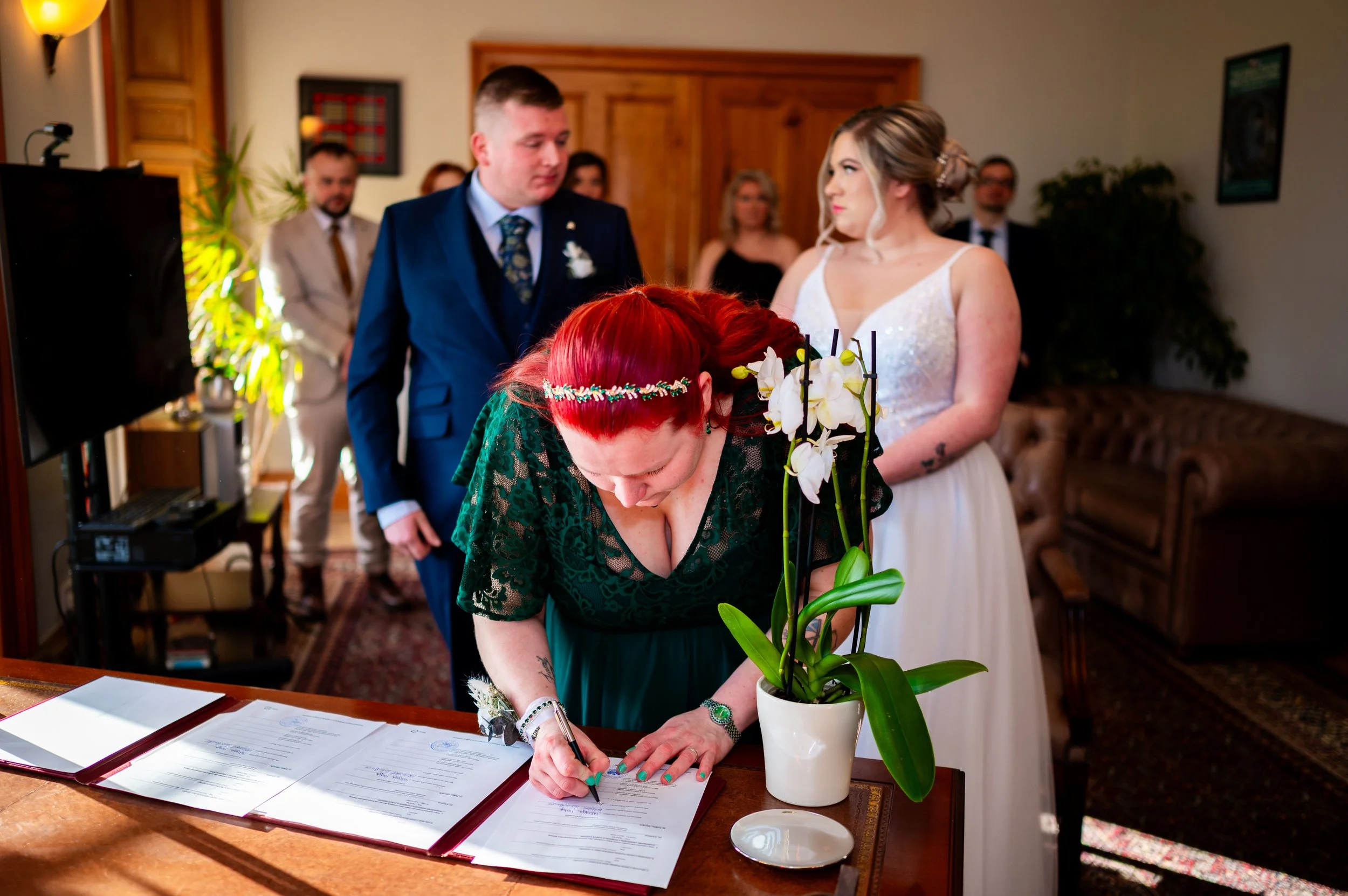 bride groom wedding ceremony family members signing papers