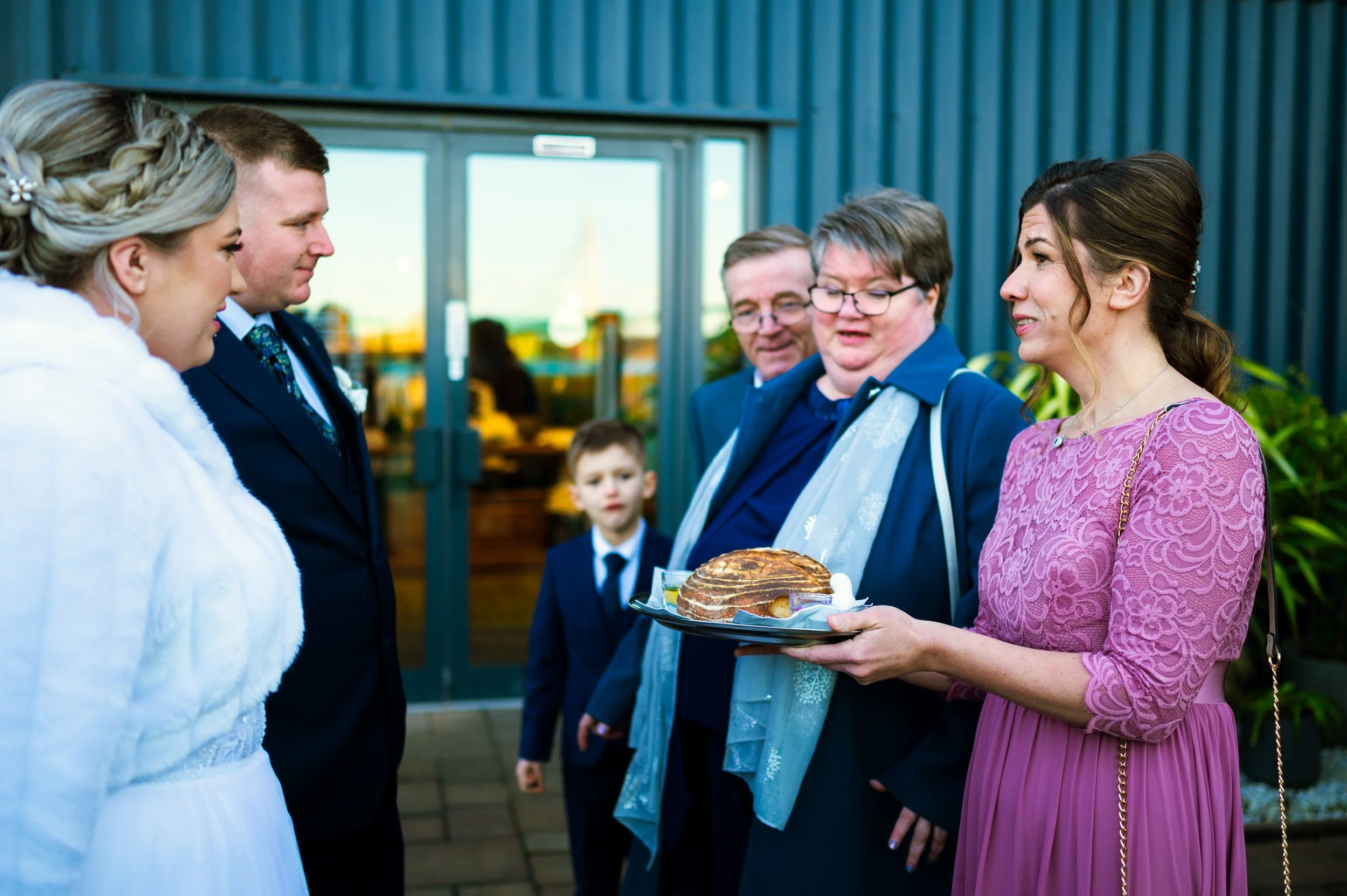 wedding reception restaurant dinner family members couple eating from the same bread polish tradition